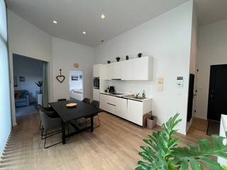 Lichtrijke leef- en eetruimte met ingerichte open keuken (koelkast, vaatwasser, oven, inductiekookplaat), met directe toegang tot het ruime terras...