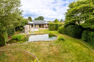 Op zoek naar rust, ruimte en groen, zonder in te boeten aan wooncomfort? Deze zeer goed onderhouden en instapklare woning combineert een royale bewoonbare oppervlakte van maar liefst 212 m² met een prachtig perceel van 1.600 m² en een heerlijke zuidgerichte tuin met zwemvijver.<br /><br />De eetkamer en leefruimte geniet van een mooi zicht op het omliggende groen en sluit aan op de moderne keuken, die in 2010 werd vernieuwd en voorzien is van alle nodige toestellen. Verder beschikt de woning over drie slaapkamers, voorzien van rolluiken en een gerenoveerde badkamer met dubbele lavabo, douche en bad (in 2021). De ruime inpandige (automatische) garage met bijkomende bergruimte zorgt voor heel wat praktisch comfort en mogelijkheden.<br /><br />De zuidgerichte tuin, de prachtige zwemvijver en de privacy zijn hier zonder twijfel een van de grootste troeven en zorgt voor een echt vakantiegevoel in eigen tuin. Achteraan in de tuin bevindt zich ook een tuinhuis.<br /><br />Daarnaast werd de woning doorheen de jaren goed onderhouden en verder verbeterd.<br />- Nieuwe condenserende gasketel geplaatst in 2023<br />- Luchtverwarmingsunit vernieuwd in 2023<br />- Hoogrendementsglas over de volledige woning (2019)<br />- Zonnepanelen en thuisbatterij (2022)<br /><br /><u>Troeven</u><br />Instapklare en zeer goed onderhouden woning<br />Perceel van 1.600 m²<br />Prachtige zuidgerichte tuin<br />Zwemvijver<br />Grote inpandige garage met bergruimte<br />Conforme elektrische installatie<br />Asbestveilig<br />Omgeven door veel groen met prachtige natuur- en wandelgebieden en het Pidpabos<br />Vlotte bereikbaarheid dankzij de nabijheid van de autosnelweg<br />Goede verbindingen met het openbaar vervoer<br /><br />Een bijzonder aangename woning voor wie houdt van ruimte, privacy en groen en tegelijk op zoek is naar een woning die meteen klaar is om in te trekken.<br /><br />Wilt u graag een bezoek inplannen? neem contact op met babette@myhomevastgoed.be of bel 0470/943624