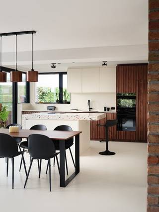Omschrijving
Unieke villa met hedendaagse architectuur
Een unieke seventies woning waar architectuur, licht en hedendaags wooncomfort samenkomen.
In de Bergstraat in Onze-Lieve-Vrouw-Waver bevindt zich deze bijzondere vrijstaande woning met een uitgesproken architecturaal karakter. De woning werd in 2024 zo goed als volledig gerenoveerd, met respect voor haar oorspronkelijke identiteit en met bijzondere aandacht voor materiaalgebruik, maatwerk , optimale ruimte indeling en uiteraard licht.
Met een ruime leefruimte en keuken, vier slaapkamers en een perceel van ongeveer 11 are biedt de woning uitzonderlijk veel ruimte. Grote glaspartijen brengen de tuin en het daglicht diep in de woning, terwijl de doordachte architectuur tegelijk voor verrassend veel privacy zorgt. Doorheen de dag volgt het zonlicht als het ware de verschillende leefruimtes.
Het hart van de woning is de royale leefruimte met haar karaktervolle zichtmetselwerk en grote raampartijen. De keuken werd volledig op maat ontworpen en hoogwaardig afgewerkt, inclusief geïntegreerde toestellen. Ook de bijpassende eettafel maakt deel uit van de verkoop. In de woning vinden we daarnaast verschillende maatkasten en een geïntegreerde bureauruimte terug, telkens ontworpen als onderdeel van het totaalconcept.
De leefruimtes lopen natuurlijk over in de veranda en de volledig aangelegde, zuidgerichte tuin. Het ruime terras met zonneluifel vormt een verlengstuk van de woning en achteraan bevindt zich een tuinhuis met overdekt terras. Door de volwassen groenstructuur geniet de tuin van veel privacy.
De woning beschikt over vier slaapkamers. Eén slaapkamer bevindt zich op de benedenverdieping, aansluitend bij de garage, en beschikt over een eigen ingerichte badkamer met douche en toilet. Hierdoor leent de woning zich ook uitstekend voor gasten, een inwonend familielid, oudere kinderen of een combinatie van wonen en werken.