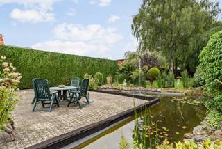 Deze vrijstaande woning bevindt zich in het aangename Arendonk en is de ideale gezinswoning door zijn centrale locatie en fraai aangelegde zuidoost gerichte tuin. De woning is voorzien van woonkamer, keuken, veranda, 4 slaapkamers, badkamer, bergruimte, inpandige garage en tuin met vijver en tuinhuis.<br /><br />Indeling:<br />U betreedt de woning via de inkomhal met apart toilet, vanwaar u rechtstreeks toegang heeft tot de lichtrijke woonkamer met sfeervolle houtkachel en aansluitende veranda met leuk uitzicht op de tuin. De praktische aparte keuken is voorzien van een vaatwasmachine, combi oven, keramisch kookvuur en koelkast en biedt voldoende ruimte voor het plaatsen van een extra eettafel. <br />Voorts kan u mits gebruik van enkele trapjes toegang krijgen tot 3 slaapkamers en badkamer met lavabomeubel, bad en toilet.<br />Op het onderste niveau bevindt er zich de inpandige garage, een extra bergruimte en een 4e slaapkamer of bureauruimte die rechtstreeks toegang geeft tot de tuin. Deze ruimte kan hierdoor ook ideaal zijn voor een praktijkruimte aan huis.<br /><br />De tuin is fraai aangelegd met een vijver, prachtige bomen en een tuinhuis achteraan. Door zijn zuidoost oriëntatie is het hier aangenaam vertoeven in de zon. De tuin is volledig omheind waardoor het een ook ideale thuis kan zijn voor huisdieren.<br /><br />Bijzonderheden:<br />- Nieuwe gasketel + recent geïsoleerd dak + dubbele beglazing<br />- Ruim, groen aangelegd perceel van +/- 1.957m²<br />- Conforme elektriciteitskeuring<br />- Geboorde waterput voor besproeiing van de tuin<br />- Centrale locatie op 2 km van de Nederlandse grens