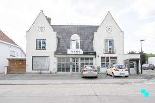 Deze instapklare eigendom in het centrum van Nieuwenhove (Waregem) biedt maar liefst 495 m² bruikbare oppervlakte (volgens EPC-attest) op een zonnig en zuidgericht perceel. De voormalige bakkerij werd gecombineerd met een ruime privéwoning met vijf slaapkamers, een werkgedeelte en afzonderlijke handelsruimte. Dankzij de voorliggende parking, carport en inpandige garage zijn er diverse parkeermogelijkheden. De winkelruimte, momenteel ingericht als bakkerij, is professioneel en kwalitatief afgewerkt, met achterliggend een atelier voorzien van o.m. koel- en diepvriescel. De zolder boven het atelier biedt extra stockage. Het privatieve deel, volledig afgescheiden en momenteel verhuurd, omvat een lichtrijke leefruimte met zithoek en houthaard, eetplaats, uitgeruste keuken met granieten werkblad en een praktische wasplaats/berging. De zuidgerichte tuin biedt maximale privacy, een tuinhuis en doorgang naar carport en atelier. Op de verdieping bevinden zich een nachthal, vernieuwde badkamer (2018), berging en vier slaapkamers, waarvan één toegang geeft tot een afgewerkte studio met eigen douchekamer en zolderruimte. Dankzij de flexibele indeling kan de woning verder verhuurd worden of eenvoudig opnieuw als één geheel worden benut. Voor meer foto's en informatie, surf naar www.bordes.be