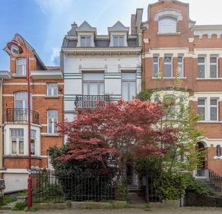 <p>Authentieke herenwoning met 4 à 5 slaapkamers en tuin in Sint-Agatha-Berchem, een ideale gezinswoning in Brussel waar ruimte, licht en karakter samenkomen. Deze charmante woning uit 1920 werd gerenoveerd en biedt een harmonieuze mix van authentieke elementen en hedendaags wooncomfort, aangevuld met energiezuinige voorzieningen zoals 9 fotovoltaïsche panelen en een degelijke gascondensatieketel, wat resulteert in een gunstig EPC.</p><p>Bij het betreden van de woning kom je in de inkomhal die toegang geeft tot zowel de leefruimtes als het volledig ingerichte souterrain op tuinniveau. De leefruimte geniet van veel natuurlijk licht en sluit naadloos aan op de eetplaats en de volledig uitgeruste keuken. Vanuit de keuken heb je directe toegang tot het terras en de aangename stadstuin.</p><p>Het souterrain is ingericht als bureauruimte en vormt een grote meerwaarde voor zelfstandigen of wie een vrij beroep uitoefent. Deze verdieping omvat daarnaast een technische ruimte, een toilet en voldoende opslagruimte en biedt directe toegang tot de tuin.</p><p>Op de eerste verdieping bevinden zich twee ruime slaapkamers, een dressing en een comfortabele badkamer uitgerust met een douche in ligbad en een dubbele wastafel, evenals een apart toilet.</p><p>De tweede verdieping omvat nog twee ruime slaapkamers, een dressing en een douchekamer. Eén van de slaapkamers beschikt over een mezzanine, bereikbaar via een vaste trap, ideaal als extra slaapruimte, bureau of hobbyruimte.</p><p>De buitenruimte vormt een echte troef met een stadstuin, terras en vijver, een oase van rust in een stedelijke omgeving.</p><p>De woning is gelegen in een mooi en rustig straatje in Sint-Agatha-Berchem, een aangename en goed bereikbare gemeente in Brussel. Je woont hier op wandelafstand van openbaar vervoer zoals tram en bus, evenals diverse handelszaken, scholen en voorzieningen, met een vlotte verbinding naar het centrum.</p><p><em>Het eigendom wordt deels overgedragen via aandelen en deels via een klassieke verkoop. Meer informatie op aanvraag.</em></p><p>Ben je op zoek naar een ruime en karaktervolle herenwoning met tuin en bureauruimte in Sint-Agatha-Berchem? Neem dan contact op via de website van Living-Stone en plan je bezoek.</p>