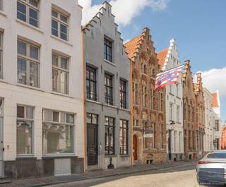 <p>Bent u op zoek naar een charmewoning in het historische centrum van Brugge? Deze woning is gelegen om de hoek van de Markt.</p>
<p>De woning werd de voorbije jaren technisch, energetisch en esthetisch gerenoveerd met o.a.: nieuwe leidingen sanitair, nieuwe verwarmingsketel, ramen, maatwerk keuken, nieuwe badkamer, airco, …</p>
<p>Daarnaast wordt het pand gekenmerkt door z’n authentieke deuren, balkwerk aan de plafonds, plafondhoogte, zichtbare dakgebintes,… . Dit alles werd behandeld tegen houtworm.</p>
<p>Indeling:</p>
<p>Gelijkvloers: royale inkomhal, leefruimte met open keuken, gelijkvloerse slaapkamer, dressing, badkamer en toegang tot de kelder (tongewelven - met technieken).<br />Eerste verdieping: tweede leefruimte met tweede keuken en tweede badkamer (momenteel gebruikt als studio voor een van de kinderen), slaapkamer 3 met toilet en douche. <br />Tweede verdieping: grote polyvalente slaapkamer, gekarakteriseerd door het zichtbare balkwerk.</p>
<p>Buiten: onderhoudsvriendelijke stadskoer.</p>
<p>De huidige eigenaars huren 2 garages in de omgeving en zijn bereid desgewenst deze huurcontracten over te dragen.</p>
<p>Van deze herenwoning genaamd “huis ‘land van belofte’ “ uw nieuwe thuis maken?</p>
<p>Contacteer Bonne Vastgoed 7 op 7 voor meer info via info@bonnevastgoed.be of 0468/10.40.40 .</p>