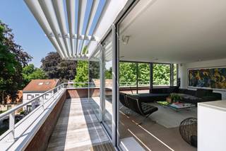 <p>In een discrete en stijlvolle residentie in Boechout bevindt zich deze buitengewone penthouse — een zeldzaam dakappartement dat de essentie van villa-wonen vertaalt naar een exclusief appartement.</p>
<p>Achter de private lifttoegang ontvouwt zich een verfijnd interieur van 156 m², waar licht, ruimte en rust centraal staan. De leefruimte, badend in zonlicht van ochtend tot avond, wordt gekenmerkt door royale glaspartijen en een subtiele interactie met het omliggende groen.</p>
<p>Het absolute pronkstuk is het 250 m² grote, rondom aangelegde dakterras — een oase van privacy en landschappelijke schoonheid. Hier beleeft u elk moment van de dag in alle sereniteit, omgeven door doordachte beplanting en harmonie.</p>
<p>Elk detail werd ontworpen met oog voor comfort en duurzaamheid: vloerverwarming, actieve koeling, warmtepomp en hoogwaardige afwerkingen zorgen voor een moeiteloze woonervaring op topniveau.</p>
<p>Met twee volwaardige suites, een elegante open keuken en praktische extra’s zoals een dubbele ondergrondse garage voor 80.000 euro en wellnessruimte, biedt dit pand een perfecte balans tussen luxe en functionaliteit.</p>
<p>Ideaal voor wie afscheid wil nemen van een klassieke villa zonder in te leveren op ruimte, standing of privacy.</p>