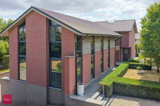 Inkomhal, living, ingerichte keuken met eiland, 3 slaapkamers (eventueel 4de slaapkamer mogelijk), 2 badkamers, dressing, bureelgebouw (of 2de woning, zorgwoning...) bestaande uit: Inkomhal met afzonderlijke ingang, 3 burelen met alle voorzieningen (ingemaakte kasten, kabelvoorzieningen...), wachtplaats, vergaderruimte, keuken (professioneel gedeelte ca 200m²). Verder is de villa volledig onderkelderd (mancave, wijnkelder, dubbele garage) en is er een parking, zonnige terrassen en zuidgerichte tuin met prachtig verzicht.