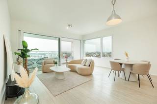 <p><span> </span></p><p><span>Want to live with Antwerp at your feet? You can here, on the eighth floor of a recently built building on Mediaplein. This bright corner apartment of approximately 86 m² features two bedrooms, radiant floor heating, ventilation, a lovely east-facing terrace, and above all: windows and views galore. The Stadspark, shops, and public transportation are nearby, and you can optionally purchase a parking space for € 30,000.</span></p><p><span>Light, space, and & views</span></p><p><span>Take the elevator to the eighth and top floor. The entryway features a videophone and provides access to the apartment’s various rooms.</span></p><p><span>The absolute highlight is the open living area of approximately 30 m². Thanks to its corner location and numerous large windows, daylight streams in from various directions, and you can enjoy sweeping views over Antwerp. There’s plenty of space for a living area and dining area, while a large sliding door connects the living space directly to the terrace. With minimal visibility from outside, you can relax here high above the city. It’s ideal for a morning coffee in the sun, with a panoramic view of Antwerp as an added bonus.</span></p><p><span>The open kitchen flows seamlessly into the living room and is practically equipped with an electric cooktop, range hood, combination oven, dishwasher, refrigerator with freezer compartment, and a double stainless-steel sink. Next to the living area, there is a separate storage room of approximately 2.5 m² containing the utility systems and hookups for a washing machine and dryer.</span></p><p><span> </span></p><p><span>Two bedrooms & e terrace with a view</span></p><p><span>Through the night hallway, you’ll reach the two bedrooms, measuring approximately 10 m² and approximately 9.5 m², respectively. Both face south, feature laminate flooring, and once again offer a beautiful view of Antwerp. The second room is ideal as a children’s room or guest room, but can just as easily be furnished as a walk-in closet or home office.</span></p><p><span>The tiled bathroom is equipped with a bathtub with a shower screen, a vanity unit, and a mirror with lighting. The wall-mounted toilet with a hand sink is located separately.</span></p><p><span> </span></p><p><span>Central Living on Mediaplein</span></p><p><span>Here, you’ll live in a super-central location on Mediaplein, with the Stadspark nearby and a Delhaize just around the corner. Even without a car, you can get anywhere easily: a Velo station is about 100 meters away, and trams and buses are within walking distance. The Central Station is nearby, and the Ring is also easily accessible. You can securely park your bike in the communal bike shed, and if you’d like your own parking spot, you can optionally purchase a parking space for € 30,000.</span></p><p><span> </span></p>