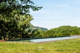 Located on a sun-drenched southern slope in Etikhove, in the heart of the Flemish Ardennes, this exceptional estate is situated on a plot of approximately 5.7 hectares. The property stands out for its combination of refined architecture, spacious volumes, and a unique location with panoramic views of the surrounding nature. Two separate entrances provide easy access and an increased sense of privacy.<br /><br />The main building of 442 m² has been carefully renovated and forms the central living space of this property. Sustainable materials, a thoughtful layout, and high-quality finishes result in a stylish and comfortable whole, suitable as a primary residence or second home.<br /><br />Adjacent to the residence is a spacious night building of 705 m² that can be perfectly arranged as a guest house, additional living space, or versatile use. A separate party barn of 210 m² provides the ideal setting for events or private receptions in a characterful setting.<br /><br />Furthermore, the domain includes a square barn of 250 m² and a separate barn of 420 m², both ideally suited for storage, workshops, craftsmanship, or expansion. For those who value relaxation and luxury outdoor living, there is a fully equipped pool house of 238 m², directly connected to the pool and surrounding terrace areas.<br /><br />Finally, there are 670 m² of stables, one of which is currently under renovation. These offer additional potential for those seeking space for animals, storage, or functional expansion. In total, this property has approximately 1,595 m² of high-quality finished buildings, which is exceptional within this segment.<br /><br />This unique estate offers a rare combination of tranquility, views, volume, and versatility, ideal for those seeking a high-quality farm, a private estate, or a multifunctional property in one of the most beautiful locations in the Flemish Ardennes.<br /><br />Exceptional gem of the Flemish Ardennes.