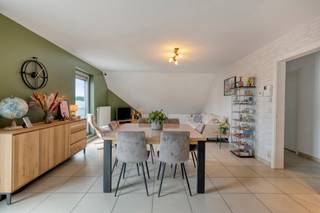 Dit centraal gelegen appartement combineert ruimte, comfort en een uitstekende bereikbaarheid. Dankzij de praktische indeling, de lichtrijke leefruimtes en de vele troeven is dit een ideale woonst voor wie op zoek is naar een instapklaar appartement met extra ruimte.<br /><br />Het appartement verwelkomt u via een inkomhal en beschikt over een ruime woonkamer met open keuken. Aansluitend bevindt zich een praktische bergruimte. Vanuit de leefruimte heeft u toegang tot het zuidgerichte terras, waar u in alle rust kan genieten van de zon.<br />Verder omvat de woonverdieping 2 slaapkamers, apart toilet en een badkamer. De zolderverdieping, bereikbaar via een vaste trap, werd ingericht als ruime 3e slaapkamer en biedt daarnaast nog voldoende mogelijkheden voor een hobbyruimte of bureau. Ook is er nog een afzonderlijke bergplaats aanwezig.<br />Een bijkomende troef is de inpandige garage met extra bergplaats, die rechtstreeks toegang geeft tot de gemene delen. Het gebouw beschikt bovendien over een lift.<br /><br />Ook technisch uitstekend: conforme elektriciteit, asbestvrije status, gunstig EPC: B - 119 kWh/m², hoogrendementsbeglazing en centrale verwarming op aardgas. Dit alles maakt het appartement volledig instapklaar.<br /><br />De strategische ligging zorgt voor een vlotte verbinding naar diverse stations, verbindingswegen en de oprit van de E40. Bovendien bevindt er zich een bushalte op slechts 200m. De landelijke ligging biedt vele leuke wandelbaantjes. P-score: B – G-score: B. Voor meer informatie of een bezoek ter plaatse: 054 23 53 83 of info@localsvastgoed.be