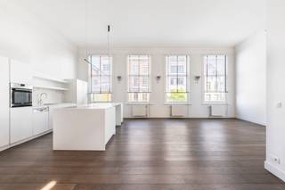<p><span>Indeling</span>: <br />Dit prachtige loftappartement op het eerste verdiep van een bel-époque gebouw aan de Paardenmarkt combineert modern comfort met authentieke charme. Met een bewoonbare oppervlakte van 125 m² geniet u van een open leefruimte met eetkamer en keuken, waar de hoge plafonds, moulures en de mooie donkerbruine parketvloer meteen in het oog springen. De grote raampartijen zorgen voor een overvloed aan lichtinval en versterken het ruimtelijk gevoel. De luxueuze afwerking komt doorheen het volledige appartement terug, waarbij modern en charmant hand in hand gaan. Via de leefruimte bereikt u de mezzanine, ideaal als bureau of tweede slaapplek. Verder is er een praktische wasruimte en een aparte wc voorzien. Achteraan het gebouw bevindt zich de ruime en rustige slaapkamer met inbouwkasten en een aansluitende badkamer met inloopdouche; hier werd bovendien vloerverwarming geplaatst voor extra comfort.</p>
<p>Het appartement beschikt over een buitenruimte en werd verwarmd met een condenserende ketel, waarbij alle meters apart zijn. Met een EPC-score C, lage maandelijkse kosten (enkel blokpolis te betalen) en slechts twee bewoners in het gebouw, biedt dit pand een unieke combinatie van rust en efficiëntie. Tot slot bestaat de mogelijkheid om een parking te huren, over te nemen van de huidige eigenaars.<br /><br /><br /><span>Omgeving</span>:<br />Gelegen aan de Paardenmarkt bevindt dit appartement zich in een levendige en gegeerde buurt van Antwerpen, op wandelafstand van het historische stadscentrum. De omgeving combineert het bruisende stadsleven met een aangename woonkwaliteit, dankzij de nabijheid van gezellige cafés, restaurants, buurtwinkels en culturele hotspots. Ook het Eilandje, het MAS en verschillende parken liggen binnen handbereik, wat zorgt voor tal van ontspanningsmogelijkheden. Bovendien is de bereikbaarheid uitstekend, met vlotte verbindingen naar het openbaar vervoer en belangrijke invalswegen. Deze centrale ligging maakt het appartement ideaal voor wie comfortabel wil wonen met alle voorzieningen en het stadsleven binnen handbereik.</p>