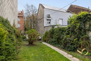 Authentiek karaktervol herenhuis uit 1926, gelegen op een perceel van 295 m² in een rustige residentiële wijk van Ganshoren. Met 248 m² verdeeld over 3 verdiepingen is dit een zeldzame eigendom, ideaal voor een groot gezin of de uitoefening van een vrij beroep — het huis herbergt momenteel een medische praktijk met onafhankelijke wachtkamer en toegang tot de tuin. De gelijkvloerse verdieping biedt een salon, een ruime eetkamer die uitgeeft op een ingerichte keuken met toegang tot het terras. De eerste verdieping telt drie slaapkamers waarvan één met aangrenzende badkamer (bad, dubbele wastafel, WC), evenals een familiesalon. Op de derde verdieping bieden twee grote mansardebureaus met zichtbare dakconstructie, velux en geïntegreerde opbergruimte uitzonderlijk veel licht en mooi vrij uitzicht.<br />Buiten completeren voor- en achtertuin, terras, tuinberging en houten chalet het geheel. De wachtkamer van meer dan 30 m² met apart toilet kan bovendien eenvoudig worden omgevormd tot extra leefruimte. Het huis is uitgerust met 14 zonnepanelen.<br />Ideaal vrij beroep • Kadastraal inkomen: 1.339 € • Vrij bij akte