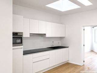 Stijlvol gelijkvloers appartement met tuin in een kleinschalig gebouw in rustig gelegen buurt.<br /><br />Het appartement werd volledig gerenoveerd en modern afgewerkt.<br />Aparte inkomhal met gastentoilet.<br />Ruime en lichtrijke woon- en leefruimte op een lichte eikenhouten parketvloer. Aansluitend de open ingerichte keuken met kwaliteitsvolle AEG toestellen : keramische kookplaat, koelkast met vriesvak, combi-oven en vaatwasser. Dit alles afgewerkt met een strak granieten werkblad. Aparte berging met aansluiting voor wasmachine en droogkast. <br /><br />Achteraan de eerste slaapkamer die toegang geeft naar de tuin. Ideaal als bureau, logeerkamer of kinderkamer. <br /><br />De master-bedroom geeft zicht op de tuin en heeft een en-suite modern ingerichte badkamer met inloopdouche en enkele lavabo met meubel.<br /><br />Privatieve kelderberging + gemeenschappelijke fietsenberging aanwezig.<br /><br />Dit appartement is geschikt voor maximum 3 personen en is beschikbaar vanaf 01/07/2026.<br />Nutsvoorzieningen apart op te nemen door de huurder.