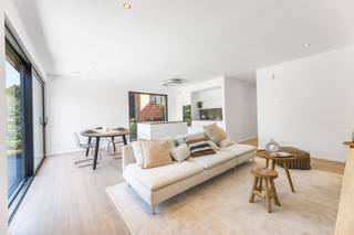 Dit prachtige gelijkvloerse nieuwbouwappartement biedt een unieke combinatie van comfort, ruimte en een strategische ligging. Met een bewoonbare oppervlakte van 105 m² en een westelijk georiënteerde tuin van maar liefst 180 m², is dit de ideale woonst voor wie houdt van zowel binnen- als buitenruimte. Bij binnenkomst betreedt u de lichtrijke leefruimte met open keuken, waar grote raampartijen zorgen voor een overvloed aan natuurlijk licht en zicht op de tuin. De keuken is stijlvol afgewerkt en voorzien van alle nodige inbouwtoestellen. Dankzij de energiezuinige warmtepomp en vloerverwarming geniet u hier van een duurzaam wooncomfort. Het appartement beschikt over twee ruime slaapkamers, een moderne badkamer, een apart gastentoilet en een praktische opbergruimte. De badkamer is voorzien van twee wastafels, een ligbad en een inloopdouche. Extra troeven zijn de aparte ingang, zonnepanelen, een fietsenstalling en een autostaanplaats met aansluiting voor elektrische wagens. De ligging is een absoluut pluspunt: op een boogscheut van het Provinciaal Domein van Kessel-Lo en vlak bij het centrum, openbaar vervoer, winkels en sportfaciliteiten. Hier woont u in een rustige omgeving met alle voorzieningen binnen handbereik. Dit instapklare nieuwbouwappartement is beschikbaar vanaf 5 januari en wordt verhuurd voor €1500 per maand, met nutsvoorzieningen op eigen naam en zonder gemeenschappelijke kosten. Interesse? Contacteer ons via 016 15 37 11 / info@homies.be.