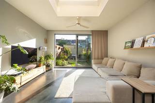 <h1><span> </span></h1><p><span>Een verrassend lichte woning met een warme uitstraling, een prachtige leefkeuken, drie slaapkamers én een gezellige tuin? Die vind je hier, in een aangename, residentiële buurt in Deurne-Zuid. Met z’n mooie mix van hout, staal en betonlook, slimme opbergruimtes en een fijne verbinding met de tuin heeft deze instapklare woning van ca. 121 m² heel wat troeven in huis!</span></p><p><span> </span></p><h3><span>Koken, tafelen en relaxen in het licht</span></h3><p><span>Je komt binnen via de inkomhal, waar je handig je jassen en schoenen kwijt kunt. Van hieruit stap je meteen de grote open keuken binnen, die met z’n warme houten kastenwand en stoere inox afwerking een echte eyecatcher is. Het grote kookeiland met chromen werkblad, geïntegreerde spoelbak en gezellige zitplek nodigt uit om samen te aperitieven terwijl er gekookt wordt. Je hebt hier een vijfpits gasvuur, dampkap, oven, ingebouwde vaatwasser en vooral héél veel kastruimte. Een grote ramenpartij zorgt voor natuurlijk licht en verluchting.</span></p><p><span>Aansluitend kom je in de gezellige leefruimte, waar de donkere vloer mooi contrasteert met de lichte muren en warme houten accenten. Er is volop plaats voor een grote eettafel en een comfortabele zithoek. De zwarte industriële schuifdeuren met glas geven het geheel extra karakter en schermen de trap, de gang, het gastentoilet met handenwasser en een handige berging stijlvol af.</span></p><p><span>Achteraan trekt de grote lichtkoepel extra daglicht naar binnen, terwijl het kamerbrede schuifraam de tuin helemaal bij de leefruimte betrekt. Zodra het zonnetje schijnt, zet je de deur open en loopt binnen moeiteloos over in buiten. In de groene tuin geniet je van een stukje gazon, siergrassen, planten en een gezellig terras waar je heerlijk kunt tafelen. </span></p><p><span> </span></p><h3><span>Warme parketvloeren en een badkamer met alles erop en eraan</span></h3><p><span>Via de houten trap met sfeervolle ingebouwde verlichting ga je naar de eerste verdieping. Op de overloop ligt een mooie parketvloer en vind je een hele reeks ingemaakte kasten. Ideaal om kleding, beddengoed en allerlei spullen netjes uit het zicht op te bergen.</span></p><p><span>De ruime slaapkamer van ca. 13 m² heeft dezelfde warme parketvloer, een groot raam en een strak, verticaal verwarmingselement. Een fijne plek om helemaal tot rust te komen.</span></p><p><span>De badkamer is een echte wellnessplek, met een moderne grijze tegelvloer, een ruime inloopdouche in betonlook met regendouche én een ligbad. Het brede badkamermeubel heeft twee witte opzetlavabo’s, ingebouwd kraanwerk en heel wat opbergruimte. De grote spiegel met houten omlijsting zorgt voor een warm accent. Je hebt hier ook een hangtoilet, een zwarte industriële radiator met handdoekdrager en twee ramen voor natuurlijk licht en verluchting.</span></p><p><span> </span></p><h3><span>Twee gezellige kamers onder het dak</span></h3><p><span>Via de stoere zwarte stalen trap met houten treden bereik je de tweede verdieping. Hier vind je nog twee gezellige slaapkamers, allebei met een parketlaminaatvloer en een groot Veluxraam dat voor veel daglicht zorgt. De schuine dakvlakken geven de kamers extra charme en dankzij de ingemaakte kasten onder het dak gaat er geen plaats verloren. Perfect als kinderkamers, logeerkamer of thuisbureau. Ook op de overloop vind je nog extra kastruimte.</span></p><p><span> </span></p><p><span>Rustig wonen met alles dichtbij</span></p><p><span>De Waterbaan ligt in een aangename, residentiële buurt in Deurne-Zuid, waar je rustig woont en toch alles binnen handbereik hebt. Voor je dagelijkse boodschappen kun je terecht bij de buurtwinkels en supermarkten in de omgeving van de Herentalsebaan. Ook scholen, andere voorzieningen en de herkenbare Sint-Rochuskerk liggen vlakbij.</span></p><p><span>De tramhalte Deurne Waterbaan bevindt zich op wandelafstand, net als verschillende bushaltes. Zo verplaats je je vlot richting het centrum van Antwerpen en de omliggende wijken. Een fijne locatie dus voor wie graag rustig woont, maar de stad niet wil missen!</span></p><p><span> </span></p><p><span> </span></p>