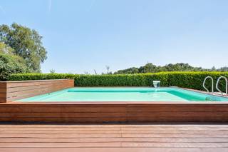 Verscholen tussen uitgestrekte weilanden en weidse vergezichten bevindt zich deze uitzonderlijke langgevelhoeve op een privédomein van 6.920 m². Een zeldzame eigendom waar de sereniteit van het platteland hand in hand gaat met een uitstekende bereikbaarheid. Dankzij de nabijheid van de E19 en A12 bereikt u Antwerpen, Brussel en Mechelen in alle comfort.<br /><br />Met respect voor haar rijke geschiedenis werd deze karaktervolle hoeve volledig gerenoveerd volgens de hoogste standaarden. Authentieke elementen werden zorgvuldig bewaard en gecombineerd met hedendaags wooncomfort, hoogwaardige materialen en moderne technieken. Het resultaat is een tijdloze woning waar karakter en verfijning elkaar moeiteloos versterken.<br /><br />De woning biedt een bewoonbare oppervlakte van 337 m² en is vandaag ingericht met twee royale slaapkamers, dressing en twee afgewerkte badkamers. Wie extra ruimte wenst, kan de woning eenvoudig uitbreiden naar drie of vier slaapkamers, zonder afbreuk te doen aan het doordachte ontwerp.<br /><br />Ook op technisch vlak voldoet dit eigendom volledig aan de hedendaagse verwachtingen, met een EPC-label B, 45 zonnepanelen, een conforme AREI-keuring en een asbestveilig attest. De villa werd ontworpen als een exclusieve privéretraite waar ontspanning centraal staat. Een verwarmd zwembad met elegant bankirai terras vormt samen met de vijver, het charmante badhuis en de exclusieve Michael Phelps Signature Swim Spa een uitzonderlijke wellnessomgeving die uitnodigt om het hele jaar door te genieten. De aangebouwde veranda, afgewerkt met een natuurstenen vloer, vloerverwaming en zonneschermen, baadt in natuurlijk licht en biedt een panoramisch uitzicht over het omliggende landschap. Tot slot is er ook een wijnkelder.<br /><br />Als vastgesteld bouwkundig erfgoed, gelegen in landschappelijk waardevol agrarisch gebied, bezit deze langgevelhoeve een uitzonderlijke zeldzaamheid. Een eigendom voor wie geen compromis wil sluiten tussen authenticiteit, privacy, ruimte en hedendaagse luxe. Een plaats waar geschiedenis zorgvuldig werd bewaard en een exclusieve levensstijl vanzelfsprekend aanvoelt.