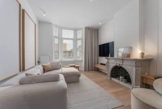 Ontdek Villa Cezanne, een project waarbij luxe en design samenkomen zonder in te boeten aan comfort. Dit high-end appartement is gelegen op de eerste verdieping en straalt werkelijk klasse uit. Bij het betreden springt onmiddellijk het maatwerk in combinatie met het witte marmer in het oog. Dit marmer keert dan ook terug in het ganse appartement. De woonkamer geniet van enorm veel lichtinval met als absolute eyecatcher de authentieke en goed bewaarde schouw die klasse uitstraalt. De marmeren keuken is hyper-uitgerust en beschikt over alle toestellen. Aansluitend aan de keuken vinden we de berging terug. De hall is voorzien van schitterend ingemaakte kasten en hier bevindt zich eveneens de technische ruimte . De 2 slaapkamers geven achteraan het appartement uit. De ene slaapkamer is voorzien van bureau in combinatie met een mezzanine zodat de ruimtes optimaal benut worden. De grote slaapkamer geeft eveneens uit op het terras zodat u telkens wakker wordt met uitzicht op het groendak. Het appartement beschikt over de modernste technieken en materialen, zo is er een ventilatiesysteem D aanwezig. Er is geen lift aanwezig waardoor de gemeenschappelijke kosten miniem zijn. Bent u op zoek naar een schitterend appartement op een absolute toplocatie? Zoek dan niet verder! Verkoop onder BTW-stelsel, verkoop onder registratie eveneens mogelijk!