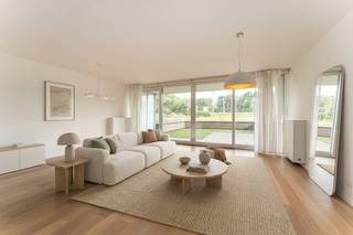 Op een toplocatie, op wandelafstand van Bredene-aan-Zee, bevindt zich dit prachtig afgewerkte gelijkvloerse appartement. Hier geniet u van de perfecte combinatie van rust en bereikbaarheid, met winkels, gezellige horecazaken, de zee én de uitgestrekte duinen binnen handbereik.<br />Een absolute troef is het ruime voorterras, waar u in alle rust kunt genieten van een weids, open zicht op de duinen. Dit unieke uitzicht zorgt elke dag opnieuw voor een heerlijk vakantiegevoel.<br /><br />Dankzij de ligging op het gelijkvloers is het appartement bijzonder vlot toegankelijk. Bovendien werd het met veel zorg afgewerkt, waarbij gekozen werd voor kwalitatieve materialen, een stijlvolle uitstraling en talrijke praktische inbouwkasten.<br /><br />De lichtrijke leefruimte vormt het hart van de woning. De grote raampartijen zorgen voor een aangename lichtinval en creëren een ruimtelijk gevoel. Hier vindt u voldoende plaats voor een gezellige zithoek en een ruime eetplaats, met directe toegang tot het zonnige voorterras en het prachtige uitzicht op de duinen.<br /><br />De open keuken sluit naadloos aan op de leefruimte en is volledig uitgerust met kwalitatieve toestellen en veel kastruimte, ideaal voor wie comfort en functionaliteit weet te waarderen.<br /><br />De moderne badkamer beschikt over een stijlvolle inloopdouche en een lavabo.<br /><br />Achteraan bevinden zich twee volwaardige slaapkamers, beide met toegang tot een tweede, rustig gelegen terras. Dankzij de terrassen aan zowel de voor- als achterzijde kunt u op elk moment van de dag genieten van zon of schaduw, volledig naar wens.<br /><br />Verder beschikt het appartement over een praktische berging met aansluiting voor wasmachine en droogkast.<br /><br />Als extra is er de mogelijkheid om een garagebox aan te kopen voor € 40.000. Daarnaast zijn er een gemeenschappelijke fietsenberging en afvalberging aanwezig.<br /><br />Kortom, een instapklaar appartement op een uitstekende ligging, met een hoogwaardige afwerking, twee zonnige terrassen én een open zicht op de duinen.