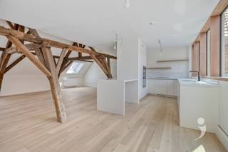 <p><span>Verkoop onder het btw-stelsel.</span><span> </span></p><p><span> </span></p><p><span>Droomt u van een exclusieve woonst in een uniek historisch kader? Dan is deze uitzonderlijke penthouse in het prestigieuze </span><span>Burenberg Monastery</span><span> zonder twijfel een buitenkans. <br />Gelegen op de tweede verdieping van het zorgvuldig gerenoveerde kloostergedeelte, combineert deze unieke residentie de authentieke charme van een beschermd erfgoed met het comfort en de luxe van hedendaags wonen. </span></p><p><span> </span></p><p><span>Met een bewoonbare oppervlakte van </span><span>133 m²</span><span> en een </span><span>zuidgericht terras van 18,60 m²</span><span> geniet u dagelijks van een adembenemend uitzicht op het historische klooster en de serene binnentuin. Hoge plafonds, grote raampartijen en de indrukwekkende originele houten dakstructuur elementen zorgen voor een unieke woonbeleving die u nergens anders vindt. </span></p><p><span> </span></p><p><span>Bij het betreden van het appartement wordt u verwelkomd in een ruime inkomhal, de hal geeft toegang tot het gastentoilet en de eerste slaapkamer. De hal leidt u verder naar de indrukwekkende leefruimte, waar de prachtig bewaarde houten dakconstructie elementen onmiddellijk alle aandacht opeist. De royale volumes en het overvloedige natuurlijke licht creëren een warme en tegelijk imposante sfeer. Aansluitend bevindt zich de volledig geïnstalleerde keuken, afgewerkt met hoogwaardige materialen die doorheen het volledige appartement werden doorgetrokken. Dankzij de grote ramen geniet u ook hier van een prachtig zicht op het klooster en heeft u rechtstreeks toegang tot het zuidgerichte terras. </span></p><p><span> </span></p><p><span>Verder beschikt het appartement over een stijlvolle bureauruimte, een dressing, een luxueuze badkamer én een ruime berging die voorzien is van de nodige aansluitingen voor was en droogmachine. Via de trap in de bureauruimte bereikt u de mezzanine, hier werd een prachtige tweede slaapkamer ingericht, waar opnieuw de originele houten dakstructuur elementen volledig tot haar recht komt. Deze unieke ruimte ademt karakter en authenticiteit en beschikt bovendien over een afzonderlijk toilet. </span></p><p><span> </span></p><p><span>Bij het appartement is er een ruime </span><span>autostaanplaats reeds inbegrepen</span><span>, afzonderlijk kan er een tweede staanplaats worden aangekocht aan </span><span>35.000 (exclusief btw).</span><span> Daarnaast beschikt het appartement over een ruime privatieve berging (7.500 exclusief btw) en een gemeenschappelijke fietsenstalling. </span></p><p><span> </span></p><p><span>Interesse in deze unieke penthouse? </span><span>Contacteer ons via 016 15 31 15 of info@immolivit.be.</span><span> </span></p><p><span> </span></p>