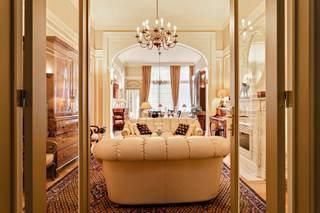 <p>The apartment is accessed via a welcoming entrance hall with built-in wardrobes. This leads to the living room, which immediately sets the tone with its beautiful archway, marble fireplace, mouldings, high ceilings, large windows and original herringbone parquet flooring,… this apartment is full of authentic features and enjoys an extremely stylish and classic appearance.</p>
<p>There is also a second lounge that can perfectly serve as a bedroom, office or hobby room.</p>
<p>The kitchen is equipped with a double sink, dishwasher, induction hob, extractor hood, eye-level oven and refrigerator. The utility room provides a practical space for a washing machine and dryer.</p>
<p>Furthermore, there is a second bedroom with an en-suite bathroom fitted with a double washbasin, walk-in shower and built-in wardrobes. The toilet is separate.</p>
<p>As the cherry on top, there is a particularly cosy terrace where you can relax and enjoy the peace and quiet.</p>
<p>Monthly charges: €275.00 (including water and heating).</p>
<p>Technical details: cellar with wine cabinet and built-in cupboards, insulated roof, wooden double glazing, security door, (fire) alarm system, videophone,…</p>
<p>The property is not located in a flood-risk area (P-score and G-score: C).</p>