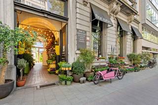 <p>Dit uitzonderlijk, imposant herenhuis is een van meest opvallende en herkenbare panden gelegen aan de Mechelsesteenweg. Een indrukwekkende gevel met rijke ornamentiek en grote raampartijen straalt standing en allure uit.</p>
<p>Het gebouw combineert historische grandeur met een eigentijdse invulling. De karaktervolle boogvormige ingang geeft toegang tot aan het binnengebied met bijgebouw.</p>
<p>Binnenin ontvouwt zich een monumentale entreehal met originele marmeren vloeren en sierlijke stucplafonds. Het gelijkvloerse niveau leent zich perfect voor commerciële doeleinde. Een monumentale houten trap met smeedijzeren leuning leidt naar de verschillende bovenliggende verdiepingen waar de woonniveau’s zijn gelegen. De ruimtes worden gekenmerkt door een comfortabele ruimtelijkheid vanwege de hoge plafonds met originele omlijstingen en de vele raampartijen.</p>
<p>De ligging spreekt voor zich: de Mechelsesteenweg is een van de belangrijkste invalswegen en handelsstraten van Antwerpen. Omgeven door winkels, horecazaken, kantoren en residentiële bebouwing, en uitstekend bereikbaar met zowel het openbaar vervoer als de wagen, geniet dit pand van een maximale zichtbaarheid.</p>