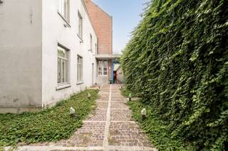 Centraal in het <strong>hart van Roeselare</strong> bevindt zich dit<strong> karaktervolle pand</strong>, waar de <strong>charme van het voormalige burgerhuis met galerij met zorg bewaard bleef</strong>. De achterliggende galerij, <strong>volledig vernieuwd</strong>, ademt nog steeds de <strong>authentieke sfeer van weleer</strong>.<br />Het pand biedt talloze mogelijkheden: van <strong>co-workingplek</strong> tot <strong>aparte kantoren</strong>. Achteraan de open hal met <strong>gietijzeren zuilen</strong> bevinden zich op elk niveau afzonderlijke vertrekken. Op het gelijkvloers zijn een compacte keuken en een technische berging voorzien.<br />Op de <strong>eerste verdieping</strong> zorgen ingebouwde kasten voor extra comfort, terwijl de<strong> houten vloer</strong> op de tweede verdieping de authenticiteit van het pand benadrukt. Van hieruit bereikt men de <strong>zolder </strong>via een vaste trap.<br />Naast de galerij ligt een bijkomende <strong>overdekte expositiezaal</strong> die zich uitstrekt over de volledige lengte.<br />Voor de galerij bevindt zich een<strong> tussengebouw </strong>met moderne sanitaire voorzieningen en een kitchenette. Via een <strong>decoratieve gang </strong>bereikt u de woning aan de voorzijde. Op de verdieping van dit deel zijn <strong>twee royale kamers</strong> ondergebracht, met daarboven een <strong>zolderverdieping</strong>.<br />Aan de voorzijde bevindt zich het <strong>elegante herenhuis met neoclassicistische gevel</strong>. De inkomhal leidt rechts naar een sfeervol salon met eetplaats, gekenmerkt door <strong>art-deco elementen.</strong> Aansluitend ligt een<strong> traditionele keuken met betegelde wanden en een stenen pompbak</strong>. De eerste verdieping telt <strong>twee ruime en twee kleinere slaapkamers</strong>, evenals een toilet. De bovenste verdieping doet momenteel dienst als <strong>kunstatelier met mezzanine.</strong><br />De unieke indeling maakt dit <strong>eigendom bijzonder geschikt als private woning, koffiehuis, brasserie of B&amp;B.</strong><br /><strong>Centrale verwarming</strong> is overal aanwezig.<br />De <strong>feeërieke binnentuin </strong>brengt<strong> licht en sfeer tot diep in het pand</strong>. Zowel de galerij als het herenhuis zijn volledig <strong>onderkelderd,  </strong>hier bevinden zich de <strong>verwarmingsinstallatie </strong>en een <strong>ruime opslagkelder.</strong><br /><br /> 