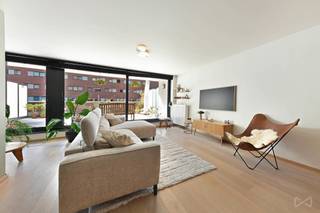 <p><span>Op een uitstekende ligging aan de bruisende Vaartkom in Leuven bevindt zich dit bijzonder ruime appartement van ca. 135 m², met een indrukwekkend zuidgericht terras van ca. 44 m². Het appartement beschikt over een EPC-label A en combineert ruimte, comfort en een uitstekende ligging vlak bij het centrum.<br /><br /></span><span>De ruime leefruimte met open keuken sluit mooi aan op het grote leefterras, dat volledig op het zuiden is gericht en uitkijkt op een aangenaam privatief groen binnenplein. Hierdoor geniet je van een rustige en groene omgeving midden in de stad. Op het terras is bovendien een regenwateraansluiting voorzien.<br /><br /></span><span>Het appartement beschikt over twee ruime slaapkamers, bereikbaar via een royale nachthal met praktische ingebouwde kasten. Ook de afzonderlijke waskamer werd voorzien van maatkasten en biedt heel wat extra bergruimte. Doorheen het appartement werd gekozen voor natuurlijke materialen zoals de volle houten parketvloer en een tijdloze afwerking. De verlichting is voorzien van dimmers, wat bijdraagt aan de aangename sfeer in de verschillende ruimtes.<br /><br /></span><span>Ook op vlak van energie en praktisch comfort scoort het appartement bijzonder goed. Het gebouw beschikt over zonnepanelen op het gemeenschappelijke dak, die bijdragen aan het verlagen van de gemeenschappelijke kosten. In de ondergrondse garage is camerabewaking aanwezig en werd reeds een voorbereiding voorzien voor het installeren van een laadpaal.<br /><br /></span><span>Een ondergrondse autostaanplaats én een private kelderberging zijn inbegrepen in de prijs. Daarnaast is er een gemeenschappelijke fietsenkelder aanwezig, eveneens met camerabewaking.<br /><br /></span><span>De ligging aan de Vaartkom vormt een absolute troef. Supermarkten, horeca, de wandelkade en verschillende recreatiemogelijkheden bevinden zich op wandelafstand. Ook het historische centrum en het station van Leuven zijn vlot te voet bereikbaar, terwijl de belangrijkste invalswegen een goede verbinding met de omgeving garanderen.<br /><br /></span><span>Een uitzonderlijk ruim en energiezuinig appartement met een groot zuidgericht terras, midden in één van de meest dynamische buurten van Leuven.<br /><br /></span><strong><span>Benieuwd naar dit appartement? Contacteer We Invest Leuven voor meer informatie of plan vandaag nog jouw bezoek.</span></strong></p>