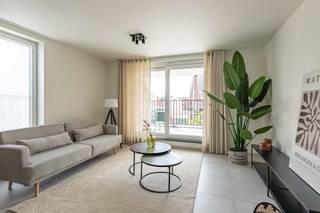<strong>775 euro/ maand + 50 euro/maand gemeenschappelijke kosten</strong><br /><br /><u>Beschikbaar vanaf 01/12/2026!</u><br /><br />📍Centraal gelegen en nabij invalswegen, op wandelafstand van winkels (apotheek, slager, bakker, ...) 🛍️, restaurants 🍽️, scholen 🎓 en de nieuwe sporthal en zwembad 🏊‍♂️!<br /><br />Een prachtig nieuwbouwappartement 🏢 volledig afgewerkt met kwalitatieve materialen en oog voor detail 👌, BEN-gekeurd ♻️, 2 slaapkamers 🛏️🛏️, ruim terras 🌿☀️, autostaanplaats nr.15 🚗 én gemeenschappelijke fietsenberging 🚲.<br /><br />U kan het appartement terugvinden op de 1ste verdieping ⬆️ bereikbaar met de lift of met de trap. Bij het binnenkomen wordt u onmiddellijk omarmd door de moderne, tijdloze sfeer perfect in balans met de hoge afwerkingsgraad en gekozen materialen. De designverlichting 💡 is een echte eyecatcher en maakt het plaatje compleet.<br /><br />Via de inkomhal heeft u links toegang tot de badkamer met douche en dubbel lavabomeubel, het gastentoilet met handenwasser 🚽 bevindt zich rechts van de inkomhal, 1ste  en 2de ruime slaapkamer 🛏️.<br /><br />De woonkamer 🛋️ met geïntegreerde eetplaats en open keuken is ruim en lichtrijk ☀️. De volledig uitgeruste keuken is voorzien van alle comfort: vaatwasser, combi-oven, koelkast, keramische kookplaat  🍳,... voldoende opbergruimte en werkplaats zodat u er ontspannen en gezellig kan kokkerellen 👨‍🍳.<br />Bovendien heeft u naast de keuken een handige berging 📦 om dranken, droge voeding,... te stockeren. Toegang tot het ruime terras 🌿 heeft u via de woonkamer.<br /><br />Verder, inbegrepen in de huurprijs 💶, heeft u een gemeenschappelijke fietsenberging 🚲 waar u privatief gebruik kan maken en een autostaanplaats 🚗 (achterkant van het gebouw).<br /><br /><u><strong>Pluspunten:</strong></u>
<ul>
	<li>BEN - gekeurd = uiterst energiezuinig! ♻️</li>
	<li>volledig afgewerkt ✅</li>
	<li>designverlichting + gordijnen aanwezig 💡🪟</li>
	<li>topmaterialen en afwerking 👌</li>
	<li>vloerverwarming 🔥</li>
	<li>ruim en lichtrijk ☀️</li>
	<li>toilet aangesloten op regenwater 💧</li>
	<li>centraal gelegen nabij allerhande winkels, invalswegen, scholen,... 📍</li>
</ul>
Heeft dit appartement uw interesse gewekt? 🤔 Bel <strong>Alicia 📞 +32 473 24 22 81 </strong>of mail<strong> alicia@vastgoedcanniere.be</strong> en maak uw afspraak 📅<br /> 