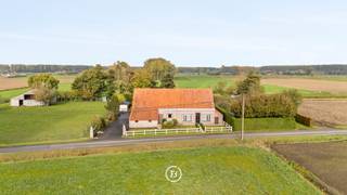 Amidst the vast Damme polder landscape lies this authentic farmhouse, peacefully located along a rural road with no through traffic. A...