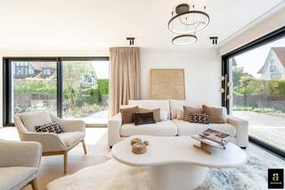 In het idyllische Tennispad in het Zoute bevindt zich deze volledig gerenoveerde villa, discreet gelegen in een rustig paadje. Dankzij de zonnige tuin rondom geniet de woning van maximale privacy en een optimale lichtinval.<br /><br />Het gelijkvloers omvat een ruime, lichtrijke leefruimte met open keuken die rechtstreeks uitgeeft op de twee terrassen, ideaal voor wie houdt van een harmonieus binnen-buitenleven. Aansluitend bevindt zich een gezellige tv-hoek en een praktische bijkeuken die mooi in het geheel geïntegreerd is.<br /><br />Op de eerste verdieping vinden we een royale master bedroom met aparte dressing en een ruime badkamer. Daarnaast is er een tweede master bedroom met ingemaakte kasten en eigen douchekamer. Verder zijn er nog twee volwaardige slaapkamers, eveneens voorzien van ingemaakte kasten. Een grote badkamer met zowel bad als douche en een apart toilet vervolledigen deze verdieping. Alle slaapkamers zijn uitgerust met airconditioning, wat het comfort het hele jaar door waarborgt.<br /><br />Het tweede verdiep biedt een zeer ruime polyvalente ruimte, ideaal als speelkamer, bureau of ontspanningsruimte. Er bestaat bovendien de mogelijkheid om hier een vijfde slaapkamer met badkamer te creëren, aangezien de technische voorzieningen hiervoor reeds aanwezig zijn. Daarnaast is er nog een royale zolderruimte beschikbaar.<br /><br />De woning is volledig onderkelderd en beschikt over een inpandige garage, aangevuld met meerdere parkeerplaatsen voor de woning.<br />Een bijzondere villa op een uiterst gegeerde locatie in het Zoute, die absoluut een bezoek waard is.
