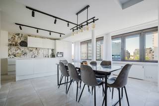 Location<br /><br />Centrally located within walking distance of the Blaarmeersen and Coupure and within cycling distance of the city centre. Easy access to public transport and the R4/E17/E40 motorways.<br /><br />Layout<br /><br />The flat is located on the 3rd floor and comprises: a spacious entrance hall, a guest toilet, a bright living room with dining area and open fully equipped kitchen with access to the terrace, a laundry room with walk-in shower, the first bedroom with terrace, a bathroom with walk-in shower and double sink, an extra storage room, the second bedroom with double bed and third bedroom. Each room is heated and cooled with a heat pump. This flat comes with the option to purchase a parking space, which is a definite bonus for everyday convenience.<br /><br />Advantages<br /><br />- Ready to move in<br />- Energy efficient<br />- Spacious<br />- Location<br /><br />For more information or to make an appointment, please contact Andreas on 0472/61.00.00.