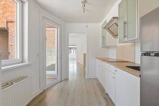 In het hart van Nieuwkerken, recht tegenover de supermarkt en op een korte wandeling van de dorpskern, vind je deze charmante woning met heel wat troeven. Het huis heeft twee slaapkamers en een ruime zolder die makkelijk kan omgetoverd worden tot een extra kamer. Dankzij de vele ramen baadt elke ruimte in het natuurlijke licht.<br /><br />De indeling is praktisch, met een handige zijingang – ideaal om fietsen of tuinmateriaal binnen te zetten. Achteraan ligt een gezellig tuintje waar je in alle rust kan genieten. Binnen is er een keuken met modern comfort en een verzorgde badkamer met ligbad.<br /><br />Ook op technisch vlak zit het goed: het dak werd recent vernieuwd, er staat een nieuwe condensatieketel, de leidingen zijn vervangen en de elektriciteit is conform tot 2047. Er geldt wel een renovatieplicht, maar die kan flink verlicht worden door purplaten tegen de zijgevel te plaatsen.<br /><br />Kortom: deze woning combineert een topligging met comfort en mogelijkheden, en is zo een fijne kans in het centrum van Nieuwkerken.