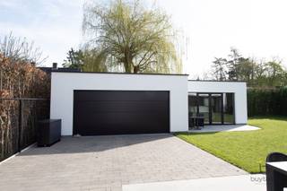 <p><span>EXCLUSIEF: Comfortabel wonen IN STIJL, denkt u aan een grote penthouse, maar wil u wonen in een rustige groene omgeving, bekijk deze exclusieve GELIJKVLOERSE villa!</span></p><p><span>Knappe energiezuinige moderne gelijkvloerse woonst + BIJGEBOUW in een aangename omgeving te Halle-Zoersel. </span></p><p><span>Luxueus wonen op de begane grond op ca 223m² met extra bijgebouw van 75m² als polyvalente ruimte, woon/werk situatie, zorgwoning,...</span></p><p><span>Dit eigendom is gelegen op een mooi stukje grond, opgeleverd in 2024, dus als nieuw, waarvan volledig het gelijkvloers is ingedeeld met inkomhal, toegang via smeedijzeren tussendeur naar de lichte leefruimte met uitzicht op de tuin en een open luxueuze ingerichte keuken met alle nodige inbouw toestellen, eveneens een dubbele vaatwasser, inductievuur, heteluchtoven, bordenverwarmer, 20m werkblad enz. Verder een ruime berging en wasplaats met technieken en aansluiting wasmachine/droogkast.</span></p><p><span>Groot schuifraam die toegang geeft tot het terras, aangelegde tuin met haag, grasrobot, volledig omheind en afgesloten met een automatische poort. </span></p><p><span>Alles is mooi afgewerkt van hoogstaande kwaliteit, opvallend zijn de plafondhoge glazen tussendeuren, ingemaakte kasten, mooie raamdecoratie, inbouwspots,... </span></p><p><span>Masterbedroom met dressing, automatische screens en ensuite badkamer met grote inloopdouche, lavabo, toilet,... deze slaapkamer heeft een schuifraam naar een open buitenruimte met privacy.</span></p><p><span>Verder op de riante nachthal is er een tweede en derde slaapkamer, waarvan 1 kamer vorzien is van een ingebouwd bureelmeubel, Er is een tweede badkamer met lavabo, douche en toilet. De slaapkamers en leefruimte zijn voorzien van airco via Daikin warmtepompsysteem (warm-koud).</span></p><p><span>Luxueuze afwerking met duurzame materialen, 16 zonnepanelen, HR TOP ketel op gas - vloerverwarming (hybride voorzieningen aanwezig), grote tegelvloer, HR+ beglazing in aluminium, stofzuigersysteem, alarmsysteem en CO² melder, gevelbepleistering Consteca, regenwaterput, E-peil 7!</span></p><p><span>Bijgebouw met overdekt terras, ideaal voor de laatste avondzon, 1 grote sectionaal poort met toegang tot een ruimte voor 2 wagens en een bijkomende polyvalente ruimte met groot raam naar de tuin, er zijn voorzieningen voor het inrichten tot kantoor/praktijkruimte, extra woonst,... momenteel in gebruik als fitness ruimte, er is drijfkracht in het bijgebouw.</span></p><p><span>Er is een vergunning voor het plaatsen van een zwembad.</span></p><p><span>Rustig gelegen met een goede verbinding naar uitvalswegen,  in de omgeving van mooie fiets- en wandelroutes en nabij het dorp van Halle.</span></p><p><span>Instapklaar, prima onderhouden, contacteer ons voor bijkomende info en plan een bezoek!</span></p><p><span> </span></p><p><span> </span></p>