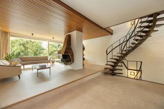 <p><span>Droom je van een woning met karakter én ruimte, waar architectuur, design en natuur samenkomen? Dan is deze unieke bel-etage aan de statige Collegelaan een buitenkans. De indrukwekkende leefruimte, authentieke sierelementen uit het laat modernisme, vier slaapkamers, een polyvalent gelijkvloers en de gezellige tuin maken van dit huis een echte blikvanger. En het Rivierenhof? Dat ligt letterlijk op het einde van de straat.</span><span> </span></p><p><span> </span></p><h3><span>Architectuur met een ziel</span></h3><p><span>Zodra je de woning binnenstapt, voel je dat dit geen doorsnee gezinswoning is. De ruime inkomhal met ingemaakte vestiairekasten geeft toegang tot de inpandige garage, een technische ruimte én een polyvalente ruimte die vandaag perfect dienst kan doen als hobbyruimte, praktijk, thuiswerkplek of zelfs kangoeroewoning. Dankzij de rechtstreekse verbinding met de tuin en de aanwezige sanitaire voorzieningen zijn de mogelijkheden hier eindeloos. </span></p><p><span>Via de iconische, stalen draaitrap — een architecturale eyecatcher die vandaag haast onbetaalbaar zou zijn om opnieuw te realiseren — bereik je de leefverdieping. Hier opent zich een indrukwekkende leefruimte van maar liefst ca. 70 m², waar grote raampartijen, hoge plafonds en de warme materiaalkeuze voor een uitzonderlijk gevoel van ruimte zorgen. De open haard vormt het sfeervolle middelpunt van de zithoek, terwijl de eetkamer naadloos overloopt in de keuken. Het maatwerkmeubilair en de originele architecturale details werden doorheen de jaren met veel zorg bewaard en geven de woning een tijdloze uitstraling.</span></p><p><span>De open keuken ademt dezelfde authentieke sfeer, maar werd tegelijk praktisch geüpdatet met kwalitatieve Miele-toestellen, waaronder een nieuwe oven, koelkast en vaatwasser. Vanuit de eetkamer stap je rechtstreeks het zonnige terras op, waar je uitkijkt over de groene tuin.</span></p><p><span> </span></p><h3><span>Vier slaapkamers en een zee van licht</span></h3><p><span>Op de tweede verdieping brengt de centrale overloop je naar vier slaapkamers, twee badkamers en een apart gastentoilet. Opnieuw speelt natuurlijk licht hier de hoofdrol dankzij de grote ronde lichtkoepel boven de hal.</span></p><p><span>De master bedroom beschikt over een ensuite badkamer met dubbele lavabo, ligbad en sfeervolle blauwe betegeling. Daarnaast zijn er nog twee ruime slaapkamers en een vierde kamer die perfect kan dienen als kinderkamer, bureau of dressing. Dankzij de grote ramen geniet elke kamer van veel licht en een mooi uitzicht op het omliggende groen.</span></p><p><span> </span></p><h3><span>Tuin vol privacy, midden in de stad</span></h3><p><span>Het terras sluit naadloos aan op de leefruimte en vormt de ideale plek voor een ontbijt in de ochtendzon of een gezellige barbecue met vrienden. Via de trap bereik je de fijne tuin, waar volwassen bomen, groen en volledige privacy zorgen voor een oase van rust. Kinderen hebben hier alle ruimte om te spelen, terwijl volwassenen genieten van het groene uitzicht.</span></p><p><span> </span></p><h3><span>Rivierenhof letterlijk om de hoek</span></h3><p><span>De ligging is zonder meer uitzonderlijk. Je woont op de statige Collegelaan, één van de meest gegeerde locaties van Borgerhout, met het Rivierenhof letterlijk op het einde van de straat. Wandelen, sporten of picknicken doe je in één van de mooiste parken van Antwerpen. Winkels, scholen, openbaar vervoer en een Velo-station bevinden zich allemaal op wandelafstand. Bovendien bereik je via de Ring of de autosnelweg in enkele minuten elke uithoek van de stad.</span></p><p><span> </span></p>