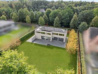 Dans un endroit particulièrement calme et résidentiel à Oud-Turnhout se trouve cette villa moderne, construite en 2014 et située sur un beau terrain de 1 750 m². La villa se distingue par son architecture épurée, ses généreux volumes de vie et son agencement réfléchi et particulièrement fonctionnel. De grandes baies vitrées offrent une abondance de lumière naturelle et renforcent la connexion entre les espaces de vie, les terrasses et le jardin. Avec quatre chambres à coucher complètes, deux salles de bains, un double garage intégré et un sous-sol complet, cette villa offre une sensation d'espace exceptionnelle et tout le confort pour une famille. Des aménagements sur mesure de haute qualité (réalisés par ILB à Kasterlee) parcourent la maison et lui confèrent une allure intemporelle et soignée. Sur le plan énergétique également, la villa convainc avec un label énergétique exceptionnel A et un score énergétique de seulement 94 kWh/m² par an.<br /><br />Rez-de-chaussée :<br />Le spacieux hall d'entrée avec vestiaire et toilettes invités forme une entrée agréable et donne accès aux différents espaces de vie. Au centre de la maison se trouve le généreux salon avec cheminée au gaz, qui, grâce à son agencement ouvert, se connecte parfaitement à la cuisine entièrement équipée. Les grandes baies vitrées offrent une agréable lumière naturelle et offrent une belle connexion avec le jardin et les vastes terrasses qui sont directement accessibles depuis le salon et la cuisine. La cuisine est équipée d'un plan de travail en Corian et d'une table à manger intégrée, et dispose d'un ensemble complet d'appareils électroménagers de qualité, dont une plaque à induction, un four à vapeur haute pression Miele, un four à chaleur tournante Miele, un réfrigérateur et un lave-vaisselle. <br />Adjacent au salon se trouve un espace bureau séparé avec bureau fixe et armoires sur mesure. Un endroit idéal pour le télétravail, l'étude ou un espace de travail paisible. Le rez-de-chaussée comprend également une buanderie spacieuse et pratique, ainsi qu'un garage double intégré avec place pour deux voitures et deux points de charge. Depuis le garage, il y a un accès direct au jardin ainsi qu'au sous-sol.<br /><br />Premier étage :<br />L'escalier depuis le hall d'entrée mène à un hall de nuit spacieux et lumineux. La suite parentale forme une zone privée complète et comprend une grande chambre à coucher, un dressing séparé et une salle de bains privative avec baignoire, douche, double vasque et toilettes. En outre, à cet étage se trouvent trois autres chambres à coucher complètes. Chacune de ces chambres est équipée de placards sur mesure pratiques et d'un bureau intégré, alliant ainsi fonctionnalité et esthétique. Une deuxième salle de bains avec douche et double vasque est à disposition de ces chambres. Le hall de nuit abrite également des toilettes séparées.<br /><br />Sous-sol :<br />Un atout particulier est le sous-sol complet de la villa. Outre une quantité exceptionnelle d'espace de rangement supplémentaire, cet étage offre de nombreuses possibilités pour une utilisation sur mesure, comme un espace hobby, une salle de fitness, une salle de jeux, une cave à vin ou un espace de stockage supplémentaire.<br /><br />Jardin & terrasses :<br />La villa est située sur un grand terrain de 1 750 m² et est entourée d'un vaste jardin qui crée un cadre verdoyant agréable et assure l'intimité nécessaire. L'ensemble est clôturé et équipé d'un portail automatique côté rue. Adjacents au salon et à la cuisine se trouvent de vastes terrasses, permettant ainsi aux espaces de vie de se prolonger naturellement à l'extérieur pendant les mois les plus chauds. La connexion directe entre la cuisine, le salon, les terrasses et le jardin rend l'ensemble particulièrement agréable à la fois pour la vie quotidienne de la famille et pour recevoir des invités.<br /><br />Confort de vie économe en énergie :