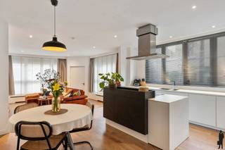 <p><strong>Zurenborg</strong> staat bekend om zijn elegante art nouveau herenhuizen, levendige pleinen en een ongeëvenaarde mix van creativiteit en cultuur. In een rustige straat, op wandelafstand van de Dageraadplaats en alle dagelijkse voorzieningen, ligt dit stijlvol en instapklaar gelijkvloers appartement dat comfort en klasse moeiteloos combineert.</p>
<p>Binnenkomend ontdek je een ruime woonoppervlakte van ca. 115 m² met een doordachte indeling. De <strong>lichtrijke woonkamer</strong> met open eetruimte vormt het hart van de woning en sluit naadloos aan op de <strong>moderne open keuken</strong> met kookeiland. Deze is volledig uitgerust met kwalitatieve toestellen van Neff en royale opbergruimte, ideaal voor wie houdt van koken en gezellig tafelen.</p>
<p>Het appartement beschikt over <strong>twee ruime slaapkamers</strong> van telkens 14 m². Een van de kamers heeft een volledig afgewerkte dressing die voor extra comfort en overzicht zorgt. De <strong>badkamer</strong> is luxueus ingericht met twee lavabo’s, een inloopdouche en een comfortabel bad. Aansluitend bevindt zich een praktische <strong>berging</strong> met aansluitingen voor wasmachine en droogkast. Daarnaast is er een apart toilet met ingewerkte kast.</p>
<p>Extra troeven zijn de gemeenschappelijke fietsenstalling vlak aan de inkom en een privatieve droge <strong>kelder</strong> van maar liefst 25 m².</p>