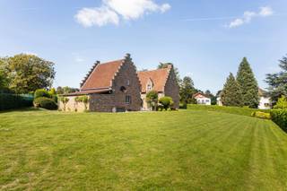 Bent u op zoek naar een instapklare villa op een strategische ligging in Groot-Bijgaarden? Dan stellen wij u graag deze charmante, landelijke woning (bouwjaar 1985) voor, gelegen op een prachtig perceel van 19 are op <strong>Hoogveld 29</strong>.<br />De woning geniet van een uitstekende bereikbaarheid: winkels, scholen, openbaar vervoer en het station van Dilbeek bevinden zich op wandelafstand. Met de wagen bereikt u vlot het centrum van Dilbeek, Ternat en de op- en afritten van de E40.<br /><br />Kortom, de ideale woning voor wie ruimte, rust en een centrale ligging wil combineren.<br /><br /><span>Indeling</span><br /><br />Via de ruime inkomhal met ingemaakte kasten, gastentoilet en een aparte bureauruimte betreden we de woning. Aansluitend bevindt zich de indrukwekkende woon- en eetkamer van maar liefst 62 m², met een plafondhoogte van 6 meter in de leefruimte, wat zorgt voor een bijzonder ruimtelijk gevoel.<br /><br />De ruime leefkeuken is volledig uitgerust en afgewerkt met kwalitatieve materialen. Vanuit de keuken heeft u directe toegang tot de pergola en het zonnige terras van 75 m², dat geniet van optimale privacy en een gunstige zuidoriëntatie.<br /><br />Op het eerste verdiep bevinden zich drie ruime slaapkamers (18 m², 19 m² en 12 m²), een badkamer met ligbad, een aparte douchekamer en een afzonderlijk toilet. De mezzanine vormt hier een absolute meerwaarde en creëert een mooie open verbinding met de woonkamer.<br /><br />De tweede verdieping (zolderverdieping) van maar liefst 58 m² is ingericht als een zeer ruime zolderkamer met sanitaire voorzieningen en bijkomende zolderruimte.<br /><br />Daarnaast beschikt de woning over een ruime kelder en een garage voor twee wagens. Boven de garage bevindt zich nog een polyvalente ruimte met douche, ideaal als hobbyruimte, bureau of extra slaapkamer.<br /><br /><span>Troeven: </span>EPC B – nieuwe ramen – elektriciteit conform – nieuwe verwarmingsketel op aardgas (2025) <br /><br />Is dit de droomwoning voor u en uw gezin? Contacteer ons vandaag nog voor een bezoek ter plaatse!<br /><br /><strong>02 887 80 56 - info@impromove.be</strong>