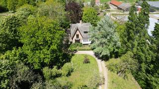 Stap binnen in een woning waar authenticiteit, <strong>geschiedenis</strong> en charme hand in hand gaan. Dit uitzonderlijke eigendom, daterend van <strong>1914</strong>, ademt karakter en onderscheidt zich door haar prachtige Angelsaksische architecturale elementen.<br /><br />Gelegen op een schitterend perceel van maar liefst <strong>3.100 m²</strong> geniet u hier van absolute rust, groen en <strong>privacy</strong>. Een zeldzame plek waar natuur en wonen harmonieus samenkomen.<br /><br />De woning beschikt over vier volwaardige slaapkamers en combineert <strong>authentieke details</strong> met hedendaags comfort. De recent gerenoveerde keuken vormt het hart van de woning en biedt alle comfort voor wie houdt van gezellig tafelen en koken in stijl.<br /><br />Daarnaast beschikt het domein over <strong>twee veelzijdige bijgebouwen</strong>:<br />Een eerste gebouw ingericht als ruime opslagplaats en garages.<br />Een tweede bijgebouw dat momenteel dienstdoet als extra slaapkamer en sfeervolle cinemazaal — ideaal voor gasten, hobby’s of ontspanning.<br /><br />Dankzij de unieke uitstraling, de royale ruimtes en het <strong>uitzonderlijke perceel</strong> biedt dit eigendom bovendien enorm veel potentieel, onder andere voor  <strong>B&amp;B-uitbating</strong>.<br /><br /> 