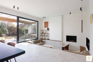 <p><span>MODERNE GEZINSWONING IN EDEGEM/ELSDONK - 205M² HEDENDAAGS WONEN</span></p><p><span>Welkom in deze prachtige, moderne woning in de rustige wijk Elsdonk. Deze uitzonderlijk ontworpen gezinswoning biedt 205 vierkante meter fraai ingerichte woonruimte verdeeld over vijf mooie slaapkamers, de perfecte oplossing voor grote gezinnen.</span></p><p><span> </span></p><p><span>ARCHITECTONISCHE UITMUNTENDHEID EN DESIGN</span></p><p><span>Deze opvallende woning heeft een verfijnde, moderne uitstraling met strakke witte gevels, donkere accenten en elegante proporties die ze laten opvallen in de woonomgeving. De woning is voorzien van hoogwaardige architectonische details, waaronder grote ramen van vloer tot plafond, naadloos geïntegreerde binnen- en buitenruimtes en doordacht ontworpen overdekte buitenruimtes met houten plafondafwerking. De woning werd recent volledig vernieuwd door SCONE ARCHITECTS.</span></p><p><span> </span></p><p><span>INTERIEUR EN INDELING</span></p><p><span>Het interieur kenmerkt zich door een magnifiek open woonconcept met hoge plafonds en veel natuurlijk licht. Het hart van de woning wordt gevormd door een moderne keuken met minimalistische witte kasten, natuurlijke houten accenten en een opvallend kookeiland  Hoogwaardige roestvrijstalen apparaten, waaronder ingebouwde ovens en een gaskookplaat, zorgen voor modern comfort en stijl. De verfijnde keuken loopt naadloos over in de ruime eet- en woonkamer met aansluitend een cousy zitput.</span></p><p><span>De woonruimtes beschikken over zitjes met verschillende niveaus, ingebouwde open haarden en grote schuifdeuren van glas die een vloeiende verbinding creëren tussen binnen- en buitenruimte. Diverse kamers profiteren van op maat gemaakte inbouwplanken en opbergoplossingen die de functionaliteit maximaliseren met behoud van een elegante uitstraling.</span></p><p><span> </span></p><p><span>SLAAPKAMERS EN PRIVÉRUIMTES</span></p><p><span>De woning omvat vijf goed ingerichte slaapkamers, zorgvuldig verdeeld over het pand. De hoofdslaapkamer heeft een eigen badkamer, inbouwkasten met hoogwaardige afwerking en uitzicht op de tuin. De overige slaapkamers bieden veel natuurlijk licht en praktische opbergruimte, ideaal voor gezinnen, gasten of een thuiskantoor.</span></p><p><span> </span></p><p><span>BUITENLEVEN</span></p><p><span>De woning beschikt over uitzonderlijke buitenruimtes, waaronder een zorgvuldig onderhouden tuin met volwassen beplanting en decoratieve planten. Luxe overdekte terrassen met stijlvolle houten pergola's bieden ideale plekken om te entertainen en te ontspannen in de buitenlucht, het hele jaar door. De buitenruimte is voorzien van een open haard, waardoor ze een uitnodigende verlenging van de woonruimte vormen.</span></p><p><span> </span></p><p><span>HEDENDAAGSE AFWERKING</span></p><p><span>In de hele woning zult u de hoogwaardige materialen waarderen, waaronder gepolijste betonnen vloeren, Mortex, moderne verlichting en een verfijnd kleurenpalet dat helder wit combineert met warme houttinten. Elk detail weerspiegelt zorgvuldige aandacht voor moderne ontwerpprincipes en kwaliteitsconstructie.</span></p><p><span> </span></p><p><span>Deze uitzonderlijke woning in Edegem biedt een zeldzame kans om een eigentijdse gezinswoning te verwerven die een verfijnd ontwerp, mooie afmetingen en praktische </span><span>functionaliteit naadloos combineert voor veeleisende huiseigenaren die op zoek zijn naar modern wonen op zijn best op een topligging in de Elsdonkwijk.</span></p><p><span> </span></p>