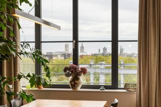 Wonen op een stukje Gentse geschiedenis, vertaald naar hedendaagse architectuur. Op de voormalige gasfabrieksite, staat nu dit indrukwekkende appartement (163m²) te koop. Het omringende park, ontworpen door Denis Dujardin rond de historische gashouders, biedt een rustige, groene oase op wandelafstand van de bruisende binnenstad. Een ongeëvenaarde toplocatie die rust combineert met een vlotte bereikbaarheid.<br /><br />Binnenkomen is een absolute beleving. De uitzonderlijke hoge plafonds en kamerbrede raampartijen trekken het daglicht rijkelijk naar binnen en onthullen een majestueus zicht op de iconische torens van Gent. De hoogwaardige afwerking springt onmiddellijk in het oog: de imposante tegels van 1,2 meter creëren een naadloze, weelderige basis die pure luxe ademt.<br /><br />De royale leefruimte vloeit prachtig over in het ruime, zuidwest-gerichte terras. Oorspronkelijk voorzien van drie slaapkamers, is het grondplan doordacht aangepast naar twee volwaardige slaapkamers en een stijlvolle open bureauruimte, perfect afgestemd op de moderne levensstijl.<br /><br />Naast het unieke wooncomfort tilt het gebouw uw levenskwaliteit nog hoger dankzij een exclusieve inpandige gemeenschappelijke fitness. Dit is resideren waar licht, ruimte en geschiedenis perfect in balans zijn.<br /><br />Het aankopen van 2 staanplaatsen in het gebouw is ook een optie. <br /><br />Interesse? Contacteer ons voor een bezoek ter plaatse. <br /><br />Bestuursmaatregelen in het maatregelenregister: nee