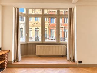 Dit appartement, dat dankzij de ruime indeling en de verdeling over meerdere verdiepingen het gevoel van een volwaardige woning biedt, bevindt zich achter een charmante gevel in een kleinschalig gebouw. De inkomhal wordt slechts gedeeld met één andere woning, die zich achteraan in het gebouw bevindt.<br /><br />U betreedt de woning via de inkomhal op het gelijkvloers, die toegang biedt tot een aparte wasplaats, een gastentoilet en de kelder. Via de traphal bereikt u de eerste verdieping, waar de leefruimte en keuken zich bevinden. De ruime leefruimte geniet aan de voorzijde van een karaktervolle erker, terwijl de volledig geïnstalleerde keuken zich achteraan bevindt. Vanuit de keuken is er rechtstreeks toegang tot het riante en zonnige terras, dat volledig vernieuwd werd.<br /><br />Op de tweede verdieping bevinden zich de twee slaapkamers en de badkamer. De master bedroom beschikt over een aansluitende dressing en een eigen balkon. De badkamer is uitgerust met een dubbele lavabo en een ruime inloopdouche en bevindt zich, samen met de tweede slaapkamer, aan de achterzijde. Verder is er op deze verdieping een afzonderlijk toilet en een handige ingebouwde kast aanwezig.<br /><br />Gemeenschappelijke lasten: 45 Euro per maand.<br /><br />Provisie voor het verbruik van water: 35 Euro per maand.<br />De nutsvoorzieningen gas en elektriciteit zijn privé op te nemen door de huurder.<br /><br />Onmiddellijk beschikbaar.