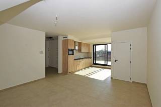 Dit gezellig appartement is gelegen op de tweede en tevens hoogste verdieping van een kleinschalig nieuwbouwproject en is bereikbaar via een lift. <br /><br />U komt binnen via de inkomhal. Grote raampartijen voor- en achteraan zorgen voor veel lichtinval in de woonkamer en de volledig ingerichte open keuken, voorzien van alle toestellen.<br />Verder omvat het appartement nog een apart toilet, een volledig betegelde badkamer met inloopdouche en toilet, een praktische (was)berging en één slaapkamer.<br /><br />Als kers op de taart geniet het appartement van een riant zuidelijk georiënteerd terras achteraan (?m²) en een fietsenstalling.<br /><br />De maandelijkse gemeenschappelijke lasten bedragen € 85/maand.<br /><br />TROEVEN:<br />° Zeer energiezuinig (E-peil 40)<br />° Ventilatiesysteem C+<br />° Hoogrendementsbeglazing<br />° Vloerverwarming<br />° 2 toiletten<br />° Z-terras (30m²) voorzien van zonneluifel<br />° Kelder<br />° Lift<br />° Overdekte afgesloten fietsenstalling<br />° Overdekte autostaanplaats<br />° Gunstige locatie nabij openbaar vervoer, winkels en scholen<br /><br />Heeft u interesse en wenst u graag een afspraak? Surf naar onze website www.vbvastgoed.be en klik op de groene knop " ik ben kandidaat ".