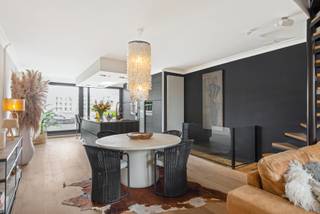 Gelegen met zicht op het water aan de stadsvesten van Lier, bevindt zich deze degelijke en hedendaags gerenoveerde woning/duplex appartement door DVO Projects.<br />Rust, veel privacy en comfort op een toch goed bereikbare locatie zijn slechts enkele troeven.<br /><br /><span><strong>Indeling</strong></span>: <br /><br /><span><strong>Gelijkvloers</strong></span>:<br />inkomhal - gastentoilet - berging/wasplaats/techn. ruimte - ingem. schoenenberging - toegang tot de kelder. <br /><br /><span><strong>Verdieping 1: </strong></span><br />leefruimte op parket met vooraan een salon/zithoek met O.H.(allesbrander met recup.warmte) en home cinema, de eetkamer en aansluitend een ingerichte leefkeuken voorzien van alle hedendaags comfort.<br />De keuken is uitgerust met een werkeiland met ontbijttoog in natuursteen voorzien van een grote spoelbak, inductievuur, dampkap, Am. koelkast, microgolfoven, oven met stoomfunctie, bordenwarmer, vaatwasm. en veel ladekasten. Via een grote schuifraam met autom. rolluik is er toegang tot het riante ZW georiënteerd terras. Het terras is voorzien van een aut. zonnescherm verlichting en verwarming. Design plantenbakken met beregeningssysteem maken het terras compleet.<br /><br /><span><strong>Verdieping 2: </strong></span><br />de hoofdslaapkamer bestaat uit 2 kamers met enerzijds het slaapgedeelte met O.H. en anderzijds een ingerichte dressing. Hier kunnen eenvoudig 2 aparte slaapkamers gecreëerd worden. Badkamer met ligbad, douche, dubb. lavabo en toilet. <br />Op deze verdieping is er eveneens een ruim en zuidwest georiënteerd terras. <br />Overal zijn er verduisteringsgordijnen aanwezig.<br /><br /><span><strong>Verdieping 3: </strong></span><br />polyvalente ruimte met ingemaakte kastenwand, momenteel ingericht als bureel/logeerkamer.<br /><br />Via de autom. poort is er toegang tot de open overdekte parkeerplaats en fietsenstalling (apart aan te kopen).<br /><br /><span><strong>Bijzonderheden</strong></span>: regenwaterput 10.000 l.-15 zonnepanelen + thuisbatterij, airco (warmen en koelen: op warmtepomp), shutters, ingebouwd muzieksysteem, rookdetectoren, EPC 145 kWh/m² - B - UC 0003203722 - Wg-Gvv-Vg-Gvkr-Gmo-Gworg