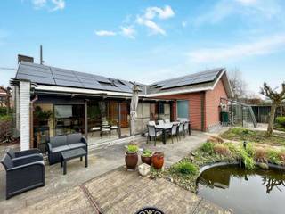 <p>Deze open bebouwing (Grondopp. 883m²) is rustig gelegen maar geniet toch van een centrale ligging nabij winkels, scholen en openbaar vervoer. De woning beschikt over een inkomhal met gastentoilet, een ruime woonkamer met eet- en zithoek, een veranda en een volledig uitgeruste keuken met eetplaats. Aansluitend is er een dubbele garage met wasplaats. Verder is er nog een berging en een bureelruimte, ideaal voor thuiswerk en/of administratie.</p>
<p>Verder op het gelijkvloers vindt u drie slaapkamers en een badkamer. De ruime zolder is ideaal als stockageruimte. De zuidgerichte tuin is voorzien van een aangelegd terras, vijver en een tuinberging.<br />De voortuin beschikt over een oprit met plaats voor twee wagen en een carport voor een mobilhome of nog eens 2 wagens.</p>
<p>Deze woning combineert een goede ligging met veel ruimte, praktische indeling en duurzame voorzieningen.</p>
<p>Extra troeven:</p>
<ul>
<li>2 regenputten van telkens 5.000 L</li>
<li>Voorzien van zonnepanelen met opbrengst van ± 6 groene stroomcertificaten/jaar (ca. €2.000)</li>
<li>Dubbele garage + carport</li>
<li>Zuidgerichte, private tuin</li>
<li>Centrale ligging met vlotte bereikbaarheid</li>
</ul>
<p>Deze villa is te koop ZONDER makelaar via het concept van Smart Houses! Wenst u verdere inlichtingen of bezoek? Contacteer rechtstreeks de eigenaar via 0478/77.64.78</p>
