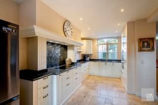 LAYOUTThrough the central entrance hall with an elegant staircase, you enter the spacious, country-style kitchen featuring a blue stone countertop...