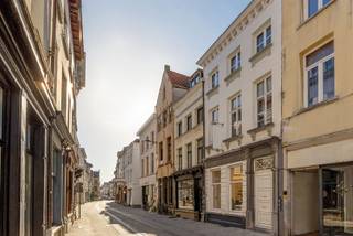 <p>Exclusive townhouse brimming with opportunity in AAA location<br />Within the beloved center of the historic city of Antwerp, behind this characterful facade lies a unique townhouse bursting with opportunity, with an impressive, usable area of no less than 360 m². <br />It offers a perfect mix of living and working, with commercial spaces on the ground floor and residential spaces on the upper floors.<br />In addition, it is only a stone's throw away from the redeveloped Schelde Kaaien, Grote Markt, Onze-Lieve-Vrouwekathedraal and Hendrik Conscienceplein. It is a very lively neighborhood that is internationally known and loved, also because of the present boutiques, restaurants , museums, galleries and most popular hotspots.</p><p>The townhouse has undergone several careful renovations with an eye on modern living comfort, both the heart and soul of this townhouse were cleverly preserved. The high ceilings, large windows, fireplaces and original planchet floors are an absolute eye-catcher and exude authenticity, style and class. Divided over three floors, it offers a sea of space and flexibility.</p><p>The ground floor can still be filled to your heart's desire thanks to the imposing rooms, kitchenette, sanitary facilities and authentic complete under vaulted arches. <br />This is currently in use as an atmospheric event location, but can just as well be used for liberal professions, a gallery and/or workshop, retail, in short, the possibilities are endless.</p><p>On the second floor is a generous living space with adjacent fully equipped kitchen and spacious south facing terrace. There is also another versatile space, currently set up as a bedroom with an ensuite stylish bathroom.</p><p>On the second floor there are two spacious master bedrooms with ensuite bathrooms and a comfortable kitchenette.</p><p>The first and second floors are currently being rented out successfully on a short-term basis via Airbnb and Booking.com. This provides an attractive return of 7% or 80K / year.<br />In short, ideal for those looking for a unique townhouse in a prime location perfect as an investment and a combination of living and working.</p>