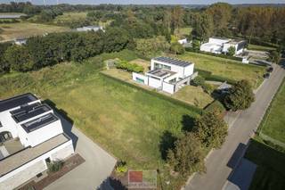 Exclusieve bouwgrond met een riante breedte van 27 m, met een oppervlakte van 2.149 m2 in het charmante Oud-Rekem – slechts enkele minuten van Maastricht!<br /><br />Bekijk de video via volgende link: https://youtu.be/dTbmNHRvgjE<br /><br />Droomt u van wonen in een prachtig groen dorp en tegelijkertijd dicht bij de levendige stad Maastricht? Dan is dit uw kans! Oud-Rekem, uitgeroepen tot 'Het mooiste dorp van Vlaanderen', biedt de ideale mix van rust, natuur en cultuur. De idyllische dorpskern met historische gebouwen, gezellige terrasjes en het indrukwekkende kasteel d'Aspremont-Lynden, brengt u terug naar vervlogen tijden.<br /><br />Dit exclusieve perceel ligt op slechts enkele minuten van Maastricht, één van de meest dynamische steden in de regio. U geniet hier van het beste van twee werelden: de rust en ruimte van een charmant Belgisch dorp en de nabijheid van het bruisende stadsleven van Maastricht, waar u volop kunt genieten van winkels, restaurants, cultuur en uitgaansgelegenheden. Dankzij de uitstekende ligging bent u bovendien snel in steden als Hasselt, Luik, Eindhoven en Aken.<br /><br />Dit ruime perceel biedt de mogelijkheid om een luxe vrijstaande villa te bouwen met twee woonlagen, kelder of garage én een zwembad. U bepaalt zelf hoe en wanneer u bouwt, zonder bouwverplichting, en heeft de optie om samen te werken met de exclusieve villabouwer Vlassak-Verhulst voor een uniek ontwerp.<br /><br />Waarom kiezen voor dit perceel?<br />- Groot perceel van ruim 2.000 m² voor een exclusieve villa.<br />- Unieke ligging: rust en natuur in Oud-Rekem, met Maastricht op slechts een steenworp afstand.<br />- Perfecte bereikbaarheid: snel in het centrum van Maastricht én goede verbindingen naar andere grote steden.<br />- Realisatie zwembad mogelijk.<br />- Geen bouwverplichting: bouw wanneer het u uitkomt.<br /><br />Verkavelingsvoorschriften<br />- Bestemming: hoofdbestemming wonen, minimaal 50% van het perceel dient voor woonbestemming.<br />- Nevenbestemming: tot 50% van het perceel kan gebruikt worden voor diensten, kantoren of vrije beroepen.<br />- Bouwvorm: open bebouwing, maximale bouwdiepte 22 meter en breedte 15 meter.<br />- Maximale bouwhoogte: 2 bouwlagen.<br />- Bouwlijn: 13 meter van de as van de straat.<br /><br />Informatie stedenbouwkundige voorschriften:<br />STEDENBOUWKUNDIGE VERGUNNING: nee<br />MEEST RECENTE BESTEMMING: gebieden voor gemeenschapsvoorzieningen en openbaar nut<br />DAGVAARDINGEN UITGEBRACHT: nee<br />VOORKOOPRECHT OP DIT GOED: nee<br />VERKAVELINGSVERGUNNING: ja<br />WATERGEVOELIG OPENRUIMTEGEBIED: nee<br /><br />Overstromingsgevoelige gebieden:<br />Perceelscore of P-score: A<br />Gebouwenscore of G-score: ONBEKEND<br />Ligging in Signaalgebied: nee<br />Ligging in afgebakende oeverzone of afgebakend overstromingsgebied: nee<br /><br />A: geen overstroming gemodelleerd B: kleine kans op overstromingen onder klimaatverandering C: kleine kans op overstromingen D: middelgrote kans op overstromingen<br /><br />Beschermd erfgoed<br />GEÏNVENTARISEERD ERFGOED: nee<br />BESCHERMD ONROEREND ERFGOED: Oude Kern Rekem (bouwkundig / landschappelijk), gebied 1629<br /><br />Extra Informatie De gemeenschappelijke park- en omgevingskosten bedragen ca. €250 per jaar. Dit omvat onder andere het onderhoud van het domein, erfgoedpremies en verzekering.<br /><br />Interesse? Wij nodigen u uit voor een kop koffie met vlaai om de mogelijkheden verder te bespreken op kantoor, bij u thuis of op 1 van de gezellige terrassen van Oud-Rekem. Dit is uw kans om een droomwoning te realiseren in een unieke omgeving, vlak bij Maastricht!<br />Exclusive Building Plot of 2,149 m² in Picturesque Oud-Rekem – Just Minutes from Maastricht!<br /><br />Are you dreaming of living in a charming green village while staying close to the vibrant city of Maastricht? This is your opportunity! Situated in Oud-Rekem, named “The Most Beautiful Village in Flanders,” this location offers the perfect blend of tranquility, nature, and culture. Its picturesque village center, complete with historic buildings, inviting terraces, and the impressive d'Aspremont-Lynden Castle, takes you back in time.<br /><br />This exclusive plot is just minutes away from Maastricht, one of the most dynamic cities in the region. Here, you can enjoy the best of both worlds: the peace and space of a delightful Belgian village and the lively city life of Maastricht, with its extensive shopping, dining, cultural, and entertainment options. Thanks to its prime location, you’ll also have quick access to cities like Hasselt, Liège, Eindhoven, and Aachen.<br /><br />This generous plot offers the opportunity to build a luxurious detached villa with two floors, a basement or garage, and even a swimming pool. You have full control over how and when you build, as there is no construction obligation. You may also collaborate with the exclusive villa builder Vlassak-Verhulst for a unique design.<br /><br />Why Choose This Plot?<br /><br />Spacious plot: Over 2,000 m² for an exclusive villa.<br />Unique location: Enjoy the tranquility of Oud-Rekem with Maastricht just a stone’s throw away.<br />Excellent accessibility: Quickly reach the center of Maastricht and enjoy easy connections to major cities.<br />Swimming pool potential: Design a home with luxurious features.<br />No construction obligation: Build at your convenience.<br />Zoning and Building Regulations<br /><br />Primary purpose: At least 50% of the plot must be residential.<br />Secondary purpose: Up to 50% may be used for services, offices, or professional purposes.<br />Building type: Open construction, with a maximum building depth of 22 meters and width of 15 meters.<br />Maximum height: Two floors.<br />Building line: 13 meters from the street axis.<br />Plot width: 27 meters, ensuring exceptional privacy.<br />Urban Planning Information<br /><br />Urban planning permit: No.<br />Most recent zoning: Community facilities and public utility areas.<br />Legal notices issued: No.<br />Preemptive purchase right: No.<br />Subdivision permit: Yes.<br />Water-sensitive open space area: No.<br />Flood Risk Information<br /><br />Plot score (P-score): A.<br />Building score (G-score): Unknown.<br />Located in signal area: No.<br />Located in designated riverbank or flood area: No.<br />Flood risk categories:<br /><br />A: No flooding modeled.<br />B: Low risk under climate change scenarios.<br />C: Small risk of flooding.<br />D: Moderate risk of flooding.<br />Heritage Protection<br /><br />Inventoried heritage: No.<br />Protected heritage: Yes, "Oude Kern Rekem" (architectural/landscape), Area 1629.<br />Additional Information<br /><br />The shared park and environment maintenance costs are approximately €250 per year, covering domain maintenance, heritage subsidies, and insurance.<br /><br />Interested?<br /><br />We invite you to discuss the possibilities over coffee and traditional Limburg pie at our office, your home, or one of Oud-Rekem’s delightful terraces. This is your chance to create your dream home in a unique setting, just moments away from Maastricht!