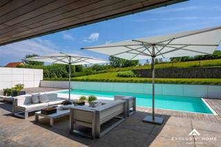 This exclusive design villa is located in a rural district of Brakel, also known as the "green pearl of the Flemish Ardennes."The impressive villa is...
