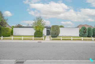 In de regio van het kasteeldomein Wallemote-Wolvenhof vinden we deze gelijkvloerse woning met <strong>drie slaapkamers</strong> op een hoekperceel van maar liefst 785m². De woning werd in 1966 gebouwd en was toen reeds een voorloper op zijn tijd. Hoewel de woning een grondige renovatie nodig heeft, zitten o.a. de indeling en lichtinval van de woning fantastisch goed. De eigenlijke kelder is te bereiken via de nachthal en biedt stockagemogelijkheden. Zeer lichtrijke en uitnodigende inkomhal, gastentoilet, toegang tot de inpandige garage, de uitbouw met bureauruimte en speelhoek / zitruimte. Verder is er de woonkamer met eet- en zitgedeelte, de keuken met zicht op het ingesloten terras, de nachthal met toegang tot ca. alle ruimtes zijnde de drie slaapkamers, de kelder, de keuken en de inkomhal. De badkamer bevindt zich momenteel ensuite tussen de masterbedroom en de grootste kinderkamer. Zeer aangename en privatieve tuin, ingesloten terras, zonneterras en aparte garagebox. CV op stookolie | Niet asbestveilig (3 materialen) | Hoofdzakelijk dubbele beglazing (HR), deels enkel glas. Alles betreft houten schrijnwerk | Regen- en putwater. Laurence (BIV 541 501) organiseert voor deze woning de bezoeken, mits het maken van een afspraak.