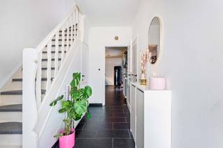 Deze ruime woning werd super netjes gerenoveerd en is dus volledig instapklaar! Ze bevindt zich op wandelafstand van het gezellige en levendige centrum van Putte: winkels, scholen en het openbaar vervoer zijn dus allemaal in de nabije omgeving. U komt de woning binnen via de inkomhal met gastentoilet, die rechtstreeks toegang verleent tot de leefruimte. De woonkamer, deels op tegelvloer en deels op laminaatvloer, kan dankzij de ramen aan 2 zijden genieten van heel wat daglicht. Het kamerhoge raam aan de achterzijde zorgt tevens voor een fijn uitzicht over de tuin. Vanuit de leefruimte bereikt u de gezellige, tijdloze keuken, voorzien van alle comfort, en de wasplaats met aansluitingen voor wasmachine en droogkast. Op de eerste verdieping vindt u 3 ruime slaapkamers en een badkamer met wastafel met meubel, douche en toilet. De houten trap op de eerste verdieping leidt u rechtstreeks naar de volledig afgewerkte zolder met laminaatvloer, die momenteel ingericht is als 4e slaapkamer. De mogelijkheid bestaat deze ruimte op te delen naar 2 volwaardige kinderkamers. Het perceel heeft een totale oppervlakte van 162m². Het huis beschikt over een gezellig, onderhoudsvriendelijk zuid-tuintje, voorzien van aangelegd terras en kunstgras. Hier kan je de hele dag van de zon genieten. Uw wagens kan u op eigen terrein kwijt op de 2 staanplaatsen voor de woning. De woning werd in 2021 uitgerust met 10 zonnepanelen!