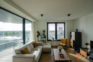 <strong>Move straight into the prestigious Ensor Tower</strong><br />Located on the <strong>10th floor of Ensor Tower in Oosteroever</strong>, Ostend, this stylish <strong>80 m²</strong> apartment, built in <strong>2021</strong>, is ready to move into.<br />Featuring two pleasant terraces, outstanding energy efficiency, and high-quality finishes, it offers modern coastal living in one of Ostend's most desirable locations.<br /><br /><strong>Bright living area with a sunny terrace</strong><br />The welcoming entrance hall with a practical cloakroom leads into a bright and inviting living room with <strong>unique sea views</strong>. Large floor-to-ceiling windows flood the space with natural light while showcasing breathtaking views.<br />The adjoining <strong>10 m²</strong> terrace enjoys the <strong>morning sun until around 2 p.m</strong>., making it the perfect spot for breakfast or a relaxing coffee in the sunshine.<br /><br /><strong>Modern open-plan kitchen</strong><br />The elegant open-plan kitchen blends seamlessly with the living area, creating a spacious and contemporary atmosphere. Its practical layout makes cooking and entertaining especially enjoyable.<br /><br /><strong>Two bedrooms with access to a second terrace</strong><br />The apartment features <strong>2 full-sized bedrooms</strong>, both fitted with <strong>built-in wardrobes</strong> and offering direct access to the generous <strong>8 m²</strong> second terrace.<br />This provides additional outdoor living space and beautiful views from both bedrooms.<br /><br /><strong>High-quality finishes and exceptional comfort</strong><br />Warm <strong>parquet flooring</strong> runs throughout the apartment and complements the comfortable <strong>underfloor heating</strong>, which is connected to the sustainable <strong>district heating network</strong>.<br />The bathroom features a walk-in shower and double washbasin, while a separate storage room and separate toilet add everyday convenience.<br /><br />With an excellent <strong>EPC rating of E43</strong> and an energy consumption of only <strong>66 kWh/m² per year</strong>, this home is exceptionally energy-efficient.<br /><br /><strong>Key features</strong><br /><span><strong>Prime location in Oosteroever</strong>, Ostend</span><br /><span><strong>Ensor Tower</strong> residence (built in <strong>2021</strong>)</span><br /><span>80 m² of living space + 2 terraces measuring 10 m² and 8 m²</span><br /><span>Underfloor heating connected to the district heating network</span><br /><span><strong>EPC E43 – 66 kWh/m²/year</strong></span><br /><span>Cadastral income: € 991</span><br /><span>Option to purchase an underground <strong>garage box</strong> (No. 56) nearby</span><br /><br /><br />Looking for an apartment for sale in Oosteroever, Ostend that combines modern comfort, outstanding energy efficiency, and a prime seaside location?<br />This apartment in Ensor Tower is a unique opportunity.