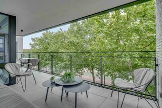 <p>Dit luxe appartement in Genk centrum met 2 slaapkamers en een ruim terras combineert hoogwaardige afwerking met instapklaar wooncomfort. Gelegen op de derde verdieping in de Kapelstraat woon je hier centraal, met winkels, horeca en het station op wandelafstand.<br /></p><p>Bij het binnenkomen valt meteen de lichtrijke leefruimte op. Grote raampartijen zorgen voor een overvloed aan natuurlijk licht en creëren een open en aangename sfeer. De leefruimte sluit naadloos aan op de open keuken, die uitgerust is met kwalitatieve toestellen en afgewerkt is met duurzame materialen. Het geheel vormt een strak en tijdloos interieur, versterkt door maatkasten die doorheen het appartement terugkomen.</p><p>Vanuit de leefruimte heb je toegang tot het ruime terras, waar je kan genieten van een groen uitzicht en een rustige buitenbeleving midden in de stad.<br /></p><p>Het appartement beschikt over twee slaapkamers, waarvan één momenteel ingericht is als een stijlvolle dressing. Deze ruimte kan eenvoudig opnieuw als slaapkamer worden gebruikt. De moderne badkamer is functioneel en verzorgd afgewerkt. Dankzij de ingebouwde kasten geniet je overal van optimaal gebruik van de ruimte en extra comfort.<br /></p><p>Een bijkomende troef is de uitzonderlijk ruime kelderberging, die veel opslagmogelijkheden biedt. Daarnaast beschikt het appartement over een ondergrondse garage met laadpunt, wat bijdraagt aan het gebruiksgemak en de toekomstgerichtheid van de woning.</p><p>Het appartement wordt volledig gemeubileerd verkocht, inclusief designmeubilair en een zorgvuldig samengesteld interieur. Dit maakt het een ideale keuze voor wie zonder zorgen wil verhuizen en meteen wil genieten van een stijlvolle woonomgeving.</p><p>De ligging is een absolute meerwaarde, met alle voorzieningen binnen handbereik en een vlotte bereikbaarheid. Dit maakt het appartement geschikt als eigen woonst of als investering.<br /></p><p>Ben je op zoek naar een instapklaar en luxueus appartement in Genk? Neem contact op en plan je bezoek.</p>